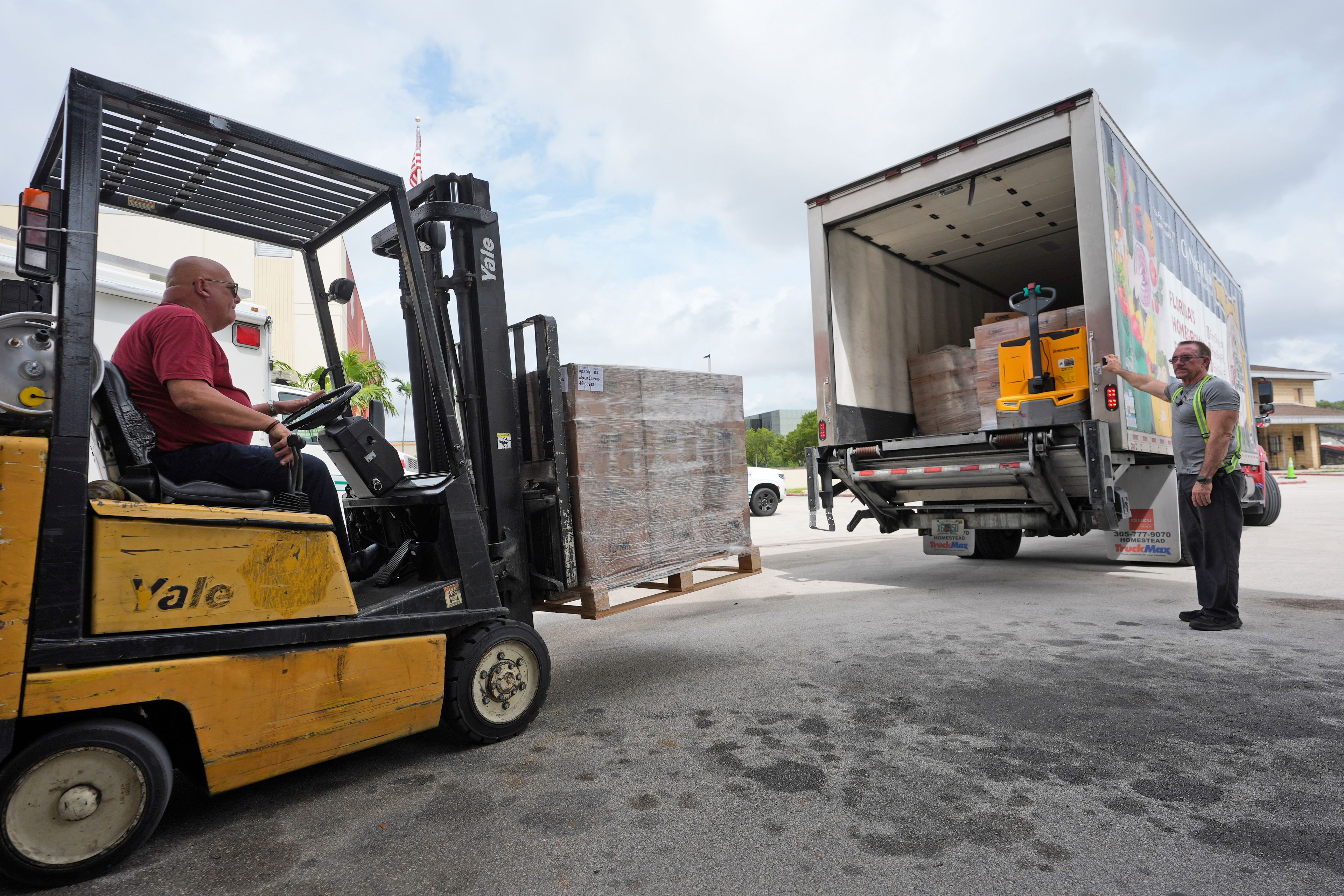 Workers load boxed meals on a Farm Share food bank truck before it leaves to aid those that may be affected Hurricane Milton as it approaches central Florida, Wednesday, Oct. 9, 2024, in Doral, Fla. (AP Photo/Wilfredo Lee)