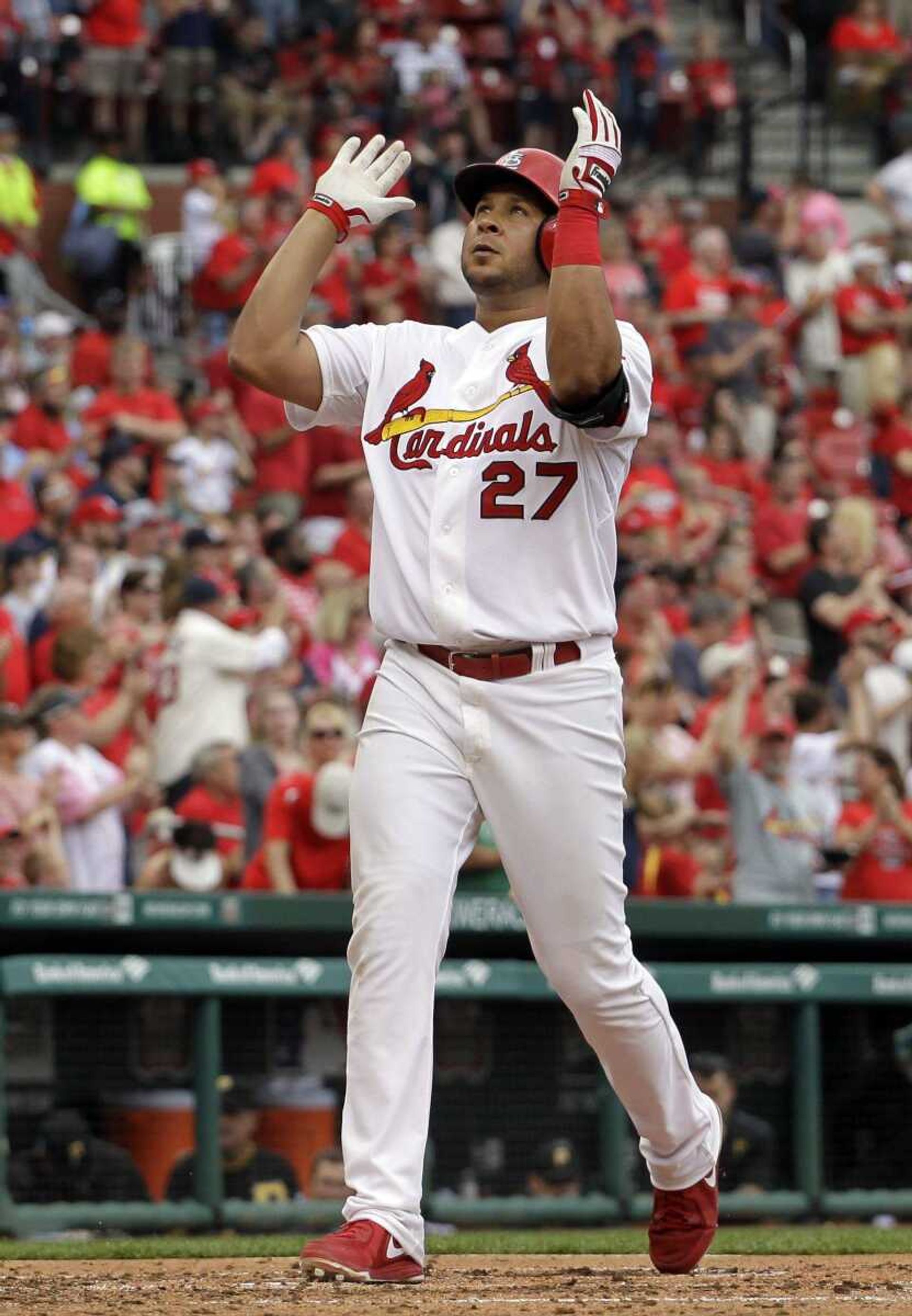 St. Louis Cardinals' Jhonny Peralta celebrates as he reaches home after hitting a solo home run during the fifth inning of a baseball game against the Pittsburgh Pirates, Sunday, April 27, 2014, in St. Louis. Peralta also hit a three-run home run in the sixth inning to help the Cardinals to a 7-0 victory. (AP Photo/Jeff Roberson)