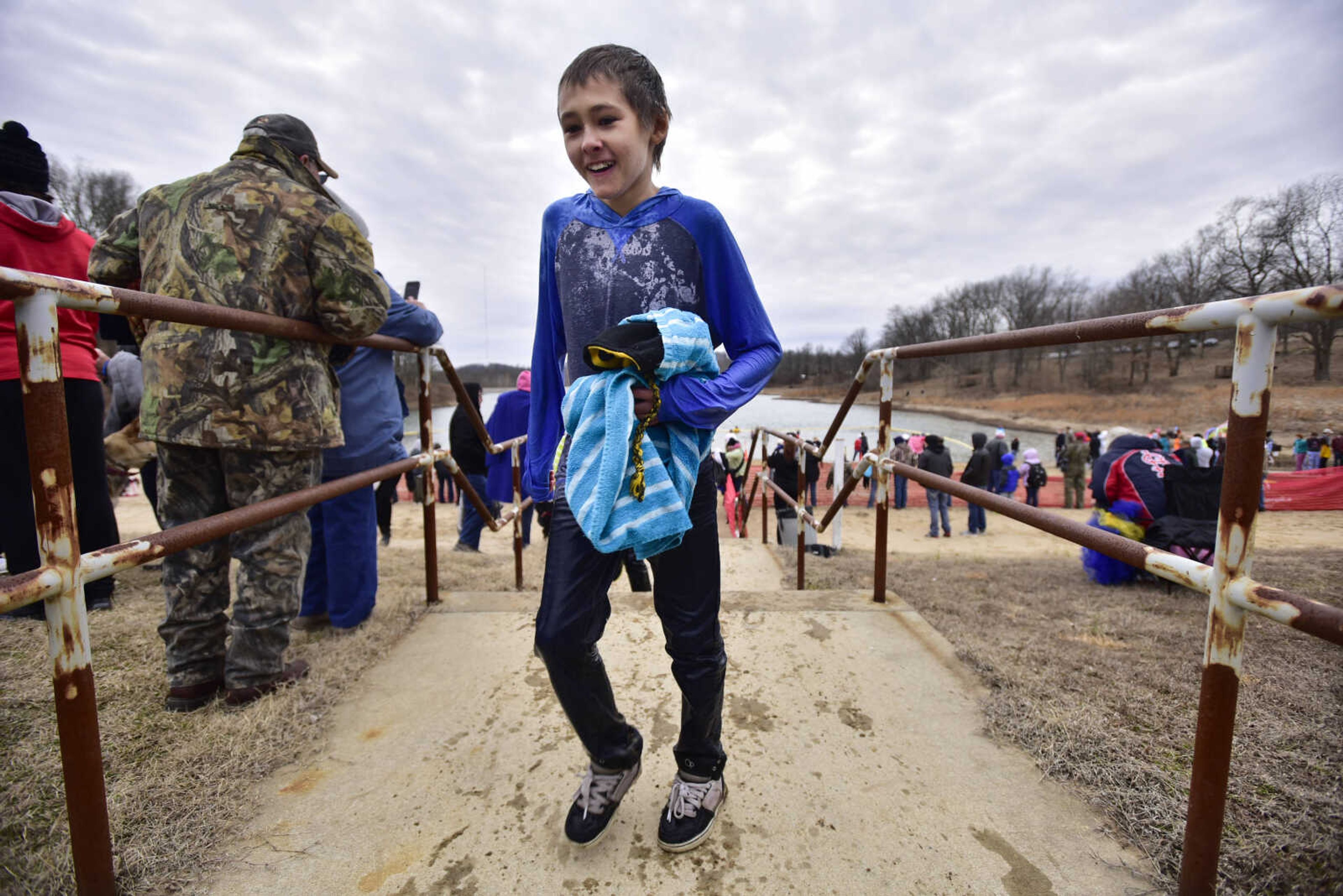 A plunger walks to a heating area after participating in the Polar Plunge benefit for Special Olympics Missouri on Saturday, Feb. 3, 2018, at Trail of Tears State Park.