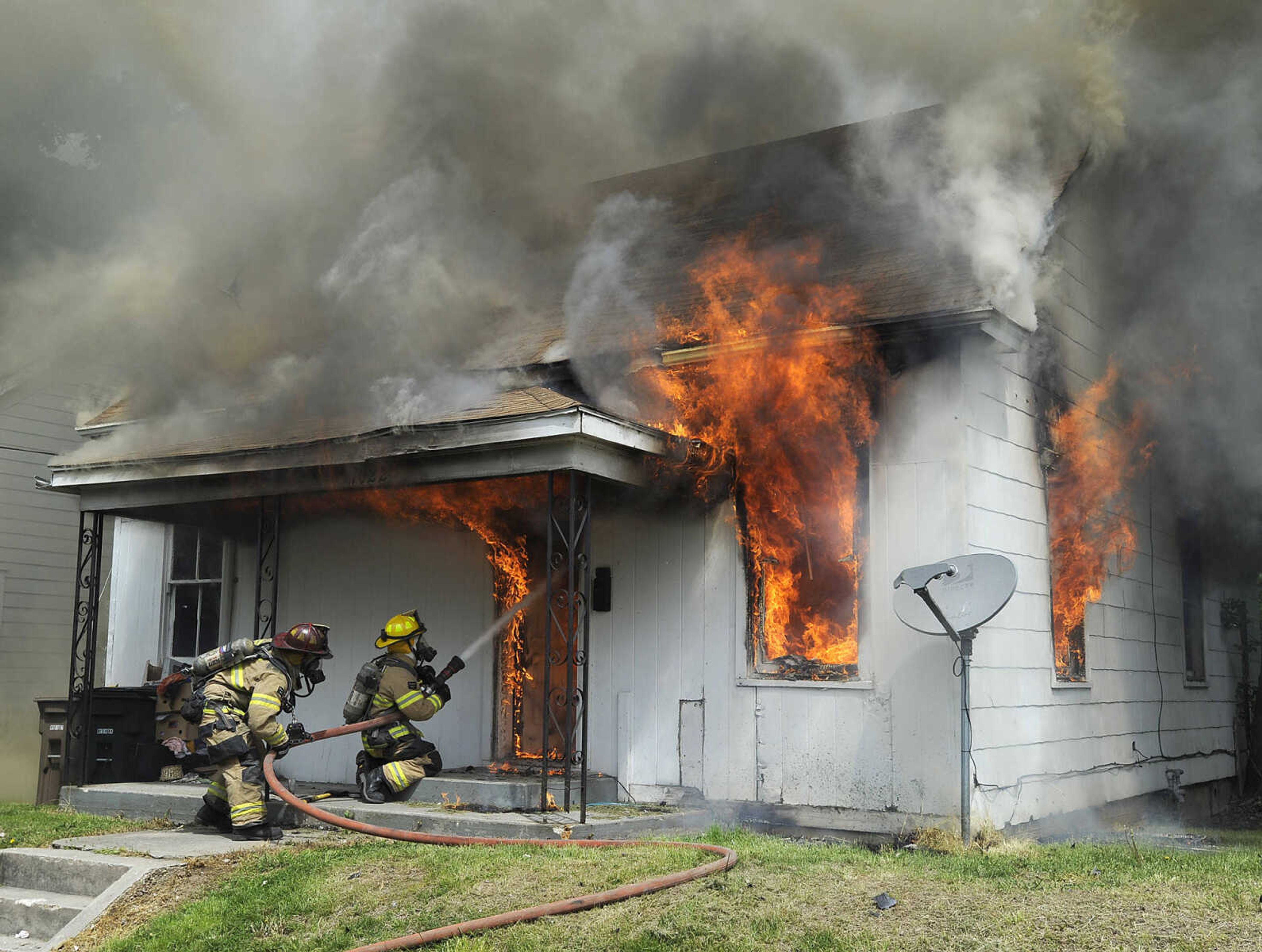 Cape Girardeau firefighters attack a fire at a vacant house Tuesday morning, April 28, 2015 at 1022 Jefferson Avenue in Cape Girardeau. (Fred Lynch)