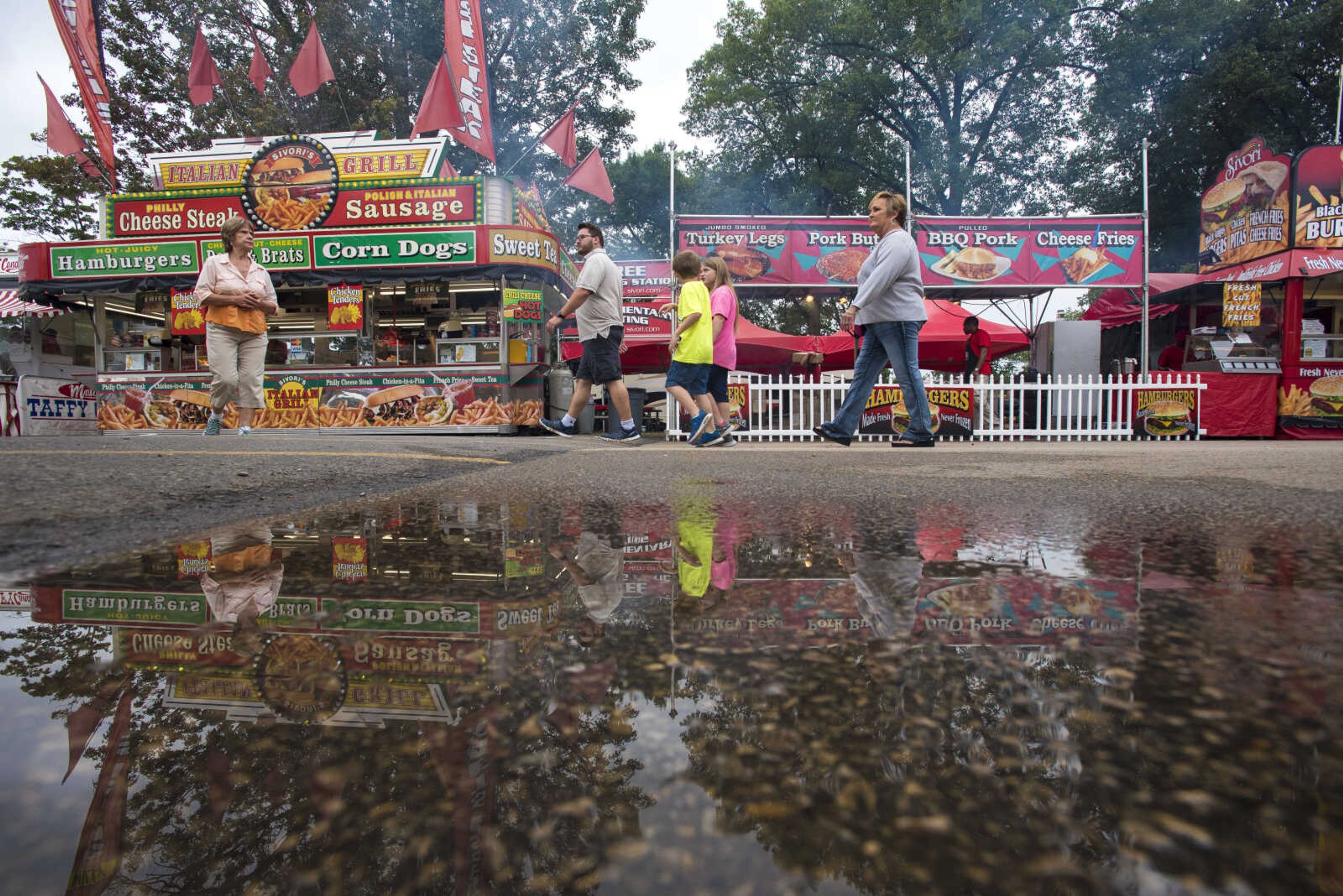 People walk around the food stands during the SEMO District Fair Wednesday, Sept. 13, 2017 at Arena Park in Cape Girardeau.