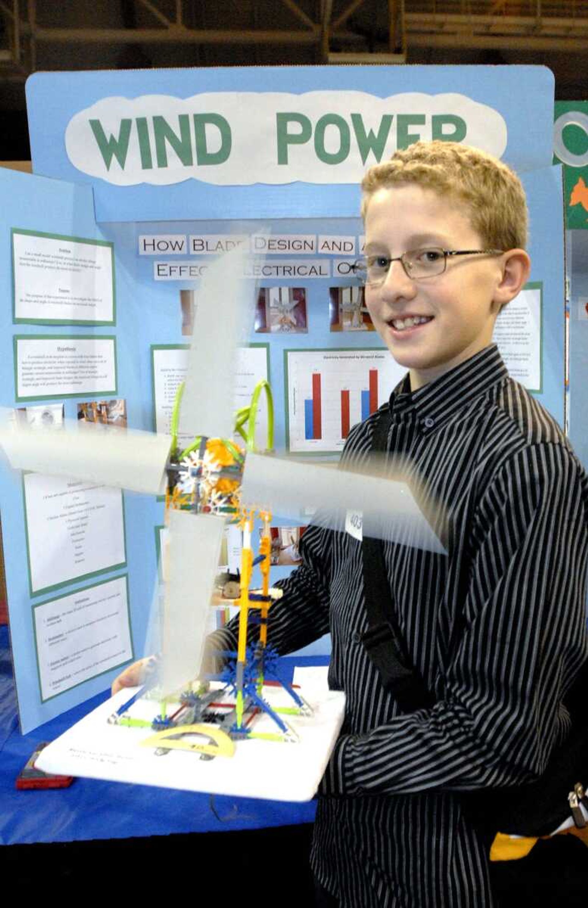 Nell Holcomb seventh-grader Brad Orenstein with his "Wind Power" science fair project Tuesday at the Show Me Center in Cape Girardeau. (Laura Simon)