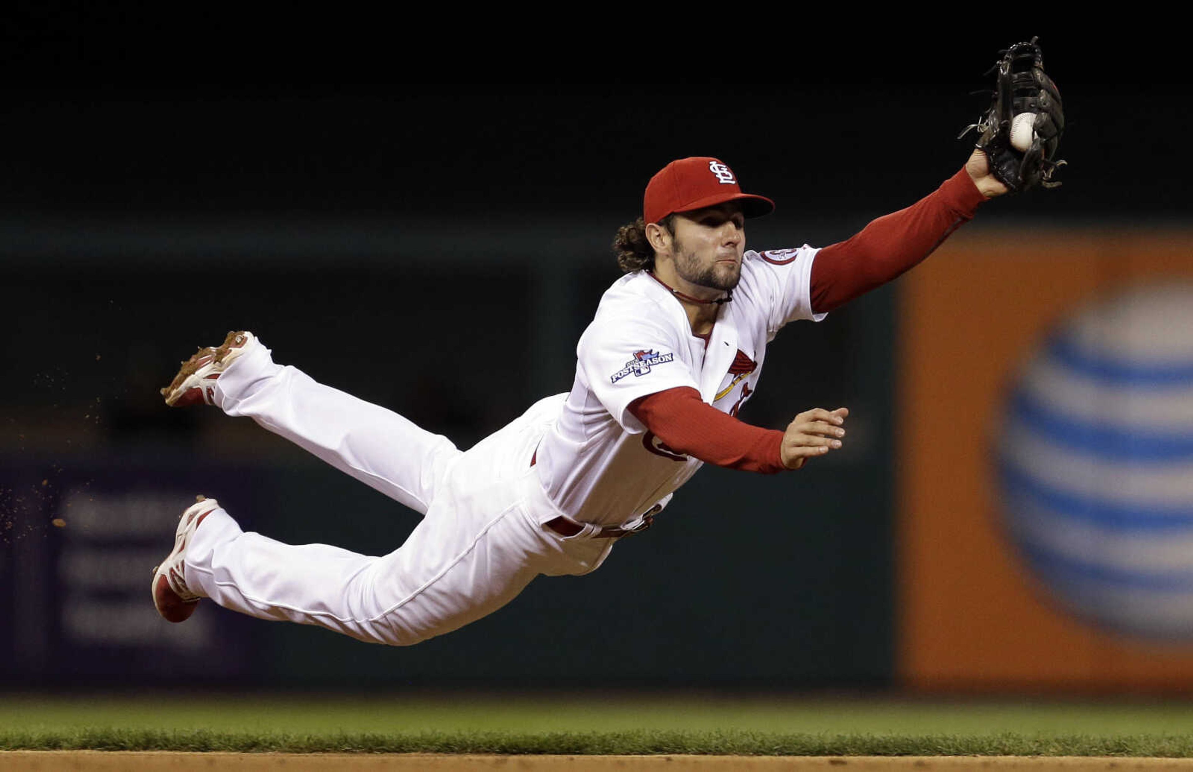 St. Louis Cardinals shortstop Pete Kozma makes a diving catch of a ball hit by Pittsburgh Pirates' Neil Walker in the fourth inning of Game 5 of a National League baseball division series, Wednesday, Oct. 9, 2013, in St. Louis. (AP Photo/Jeff Roberson)