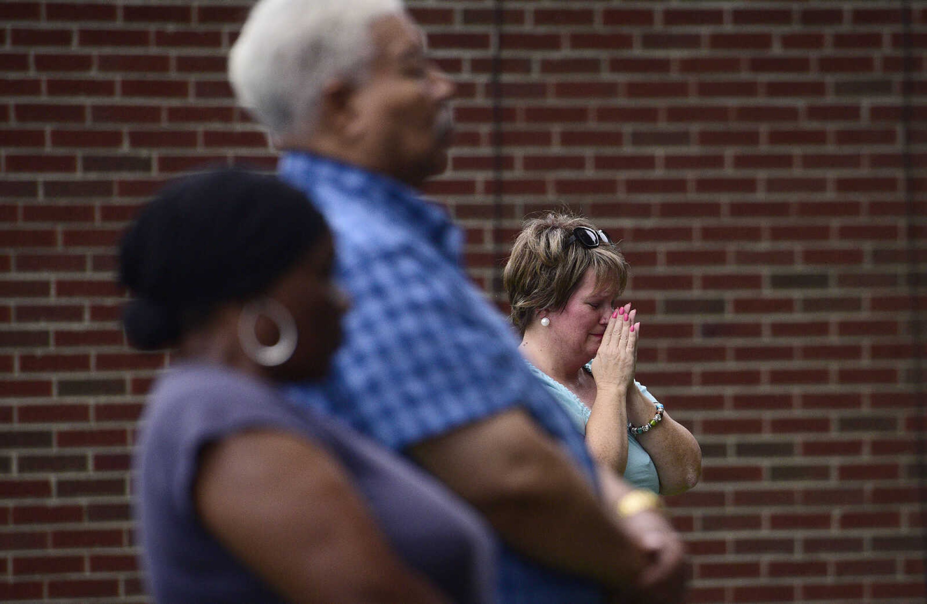 Rev. Renita Green, pastor of St. James AME, sheds tears during the Love, Not Hate rally on Sunday evening, Aug. 13, 2017, at Ivers Square in Cape Girardeau.