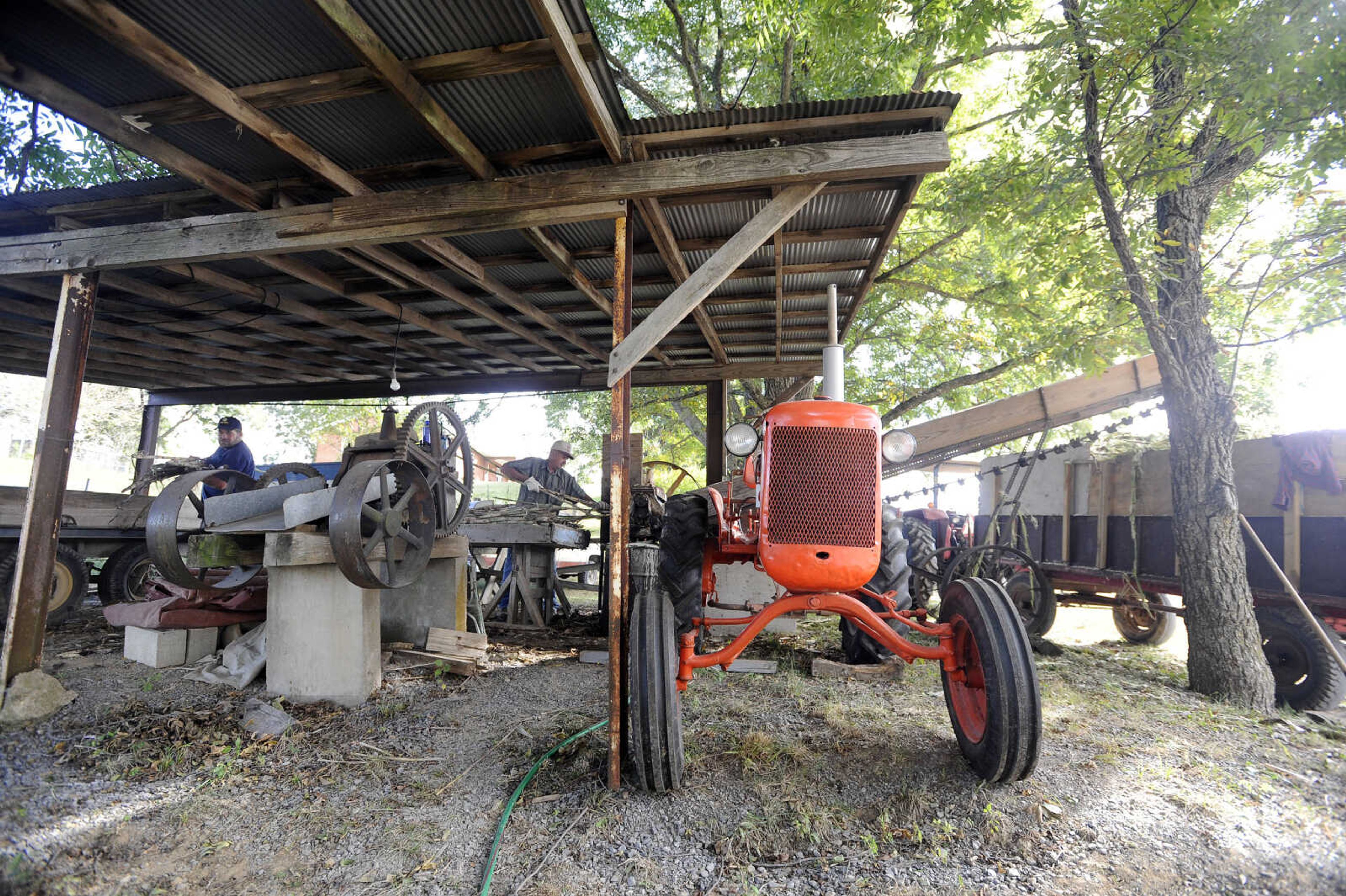 LAURA SIMON ~ lsimon@semissourian.com

Daryl Ross, left, and Paul Meyer run the sorghum press, which is powered by an Allis-Chalmers tractor, at Ralph Enderle's New Hamburg, Missouri home on Monday, Oct. 10, 2016.