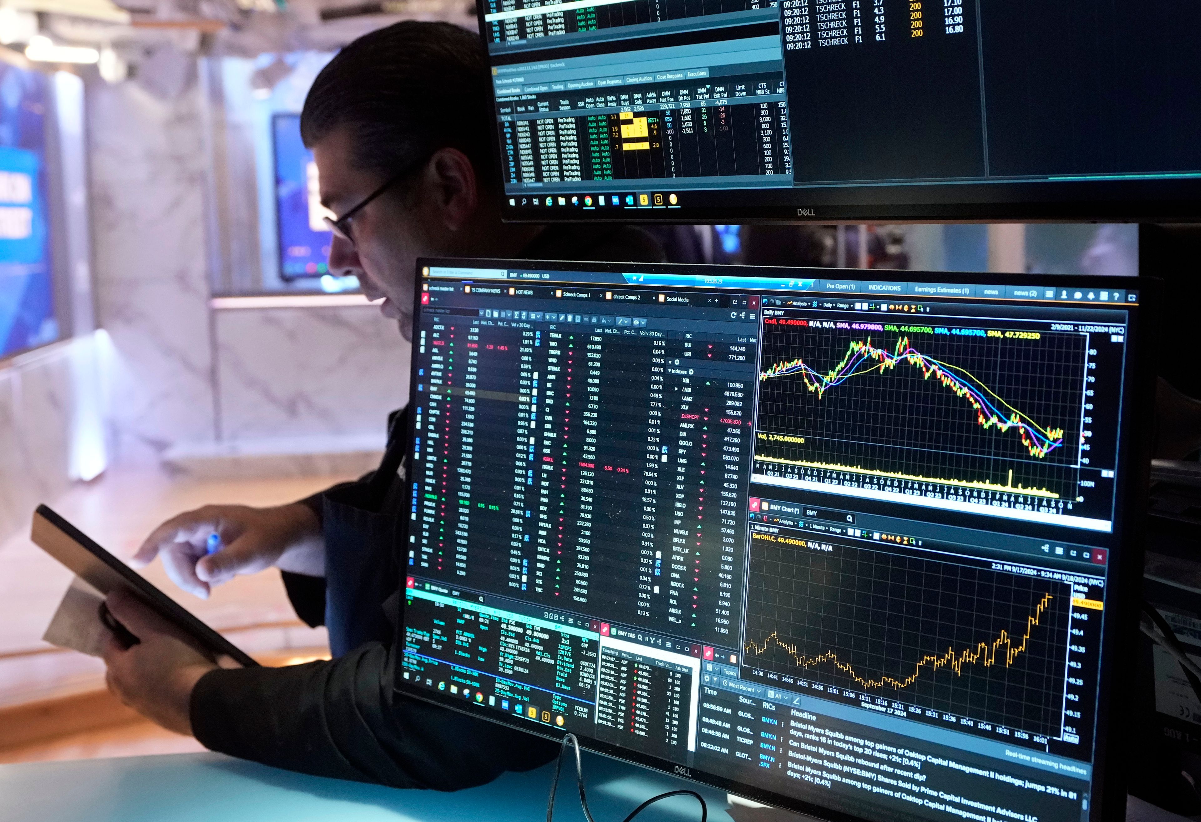 Trader Michael Capolino works on the floor of the New York Stock Exchange, Wednesday, Sept. 18, 2024. (AP Photo/Richard Drew)