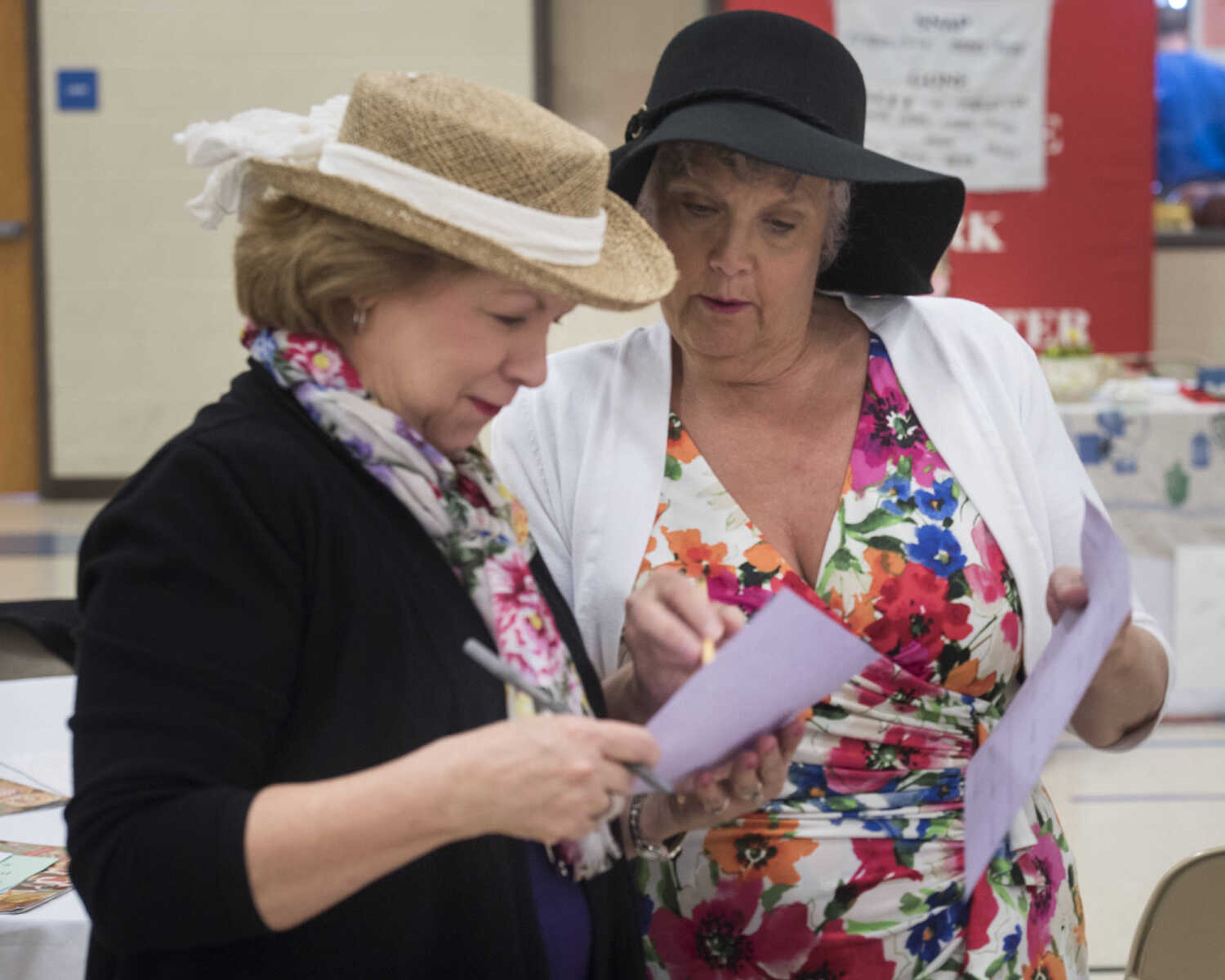 Helen Jones and Karen Ward socialize during an icebreaker at a ladies' tea and sweets event hosted by Stop Needless Acts of Violence Please on April 1, 2017 at the Shawnee Park Center in Cape Girardeau.