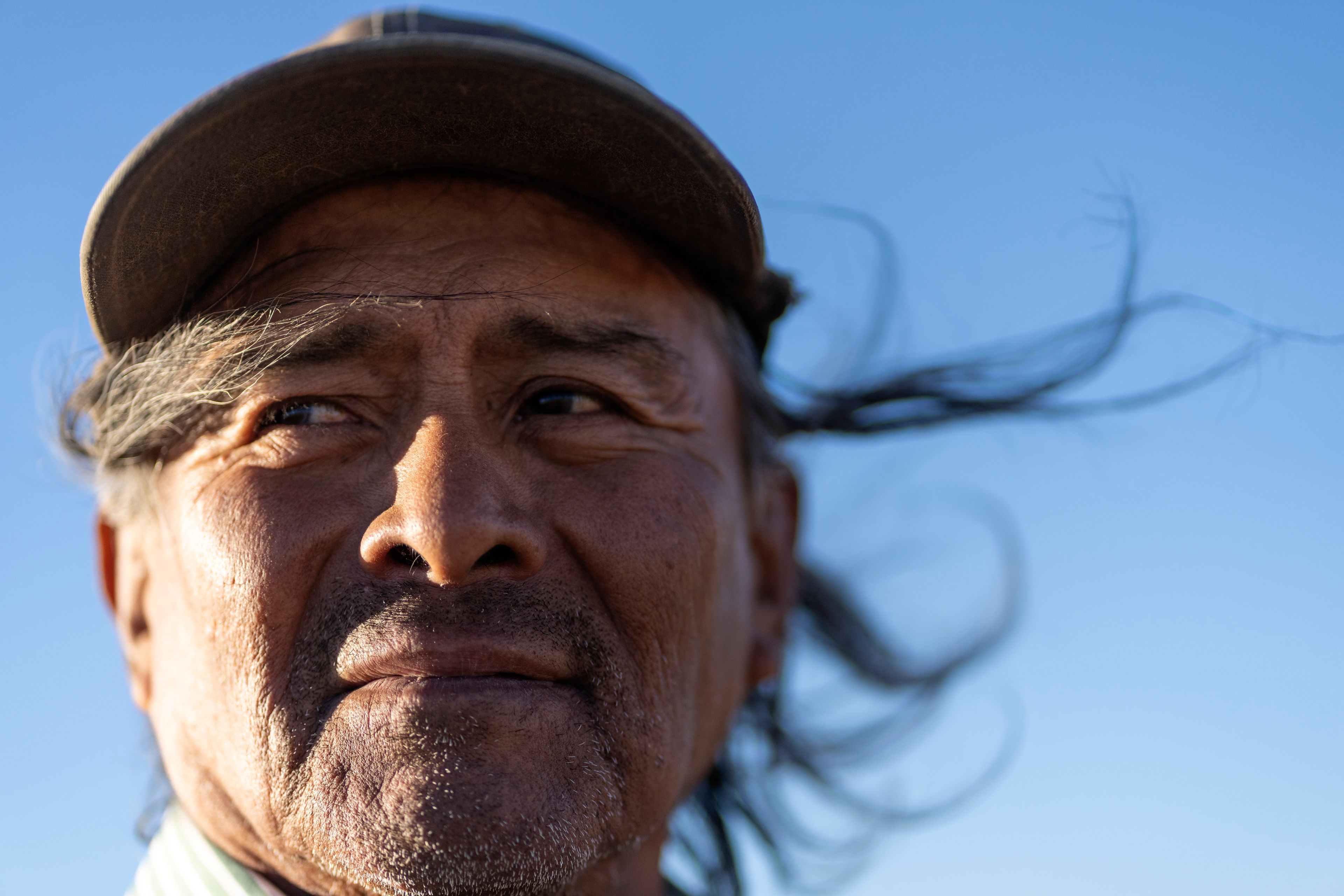 Navajo Richard Begay poses for a portrait while taking a break from herding his goats, on the Navajo Nation in Dilkon, Ariz., Thursday, Oct. 17, 2024. Native people were first recognized as U.S. citizens 100 years ago, but Arizona prevented them from exercising their right to vote until 1948. (AP Photo/Rodrigo Abd)