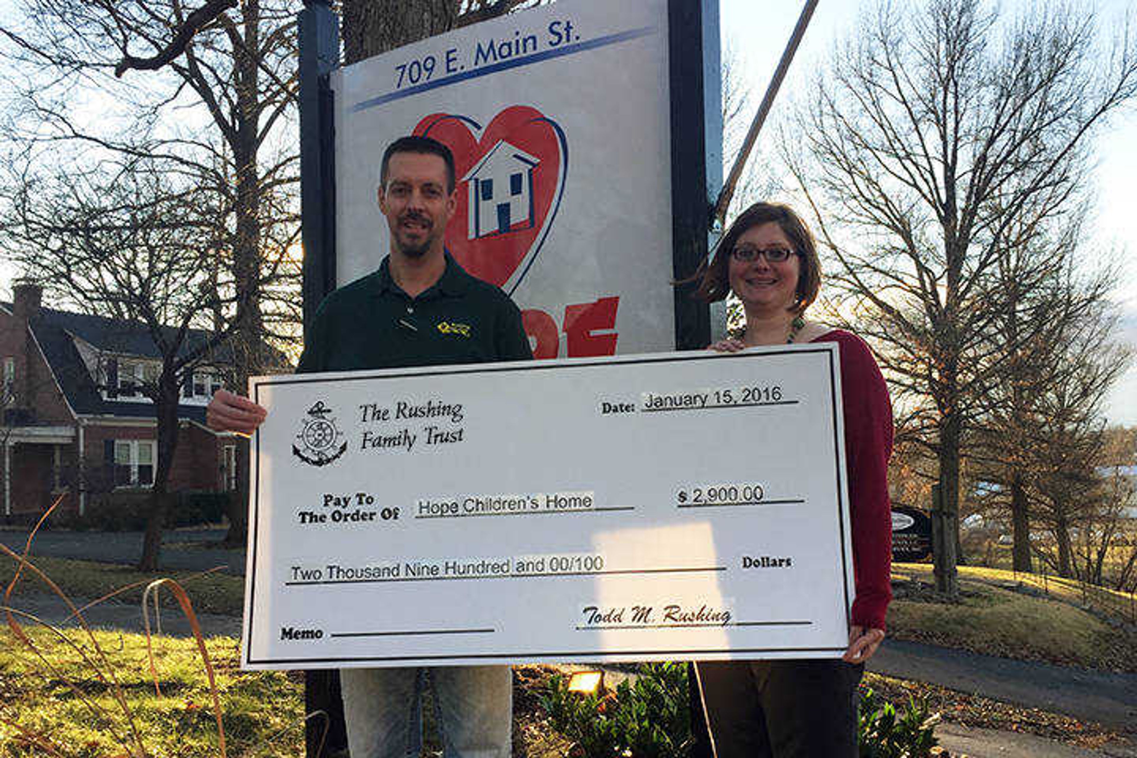 Todd Rushing, representing The Rushing Family Trust, presents donation to Crissy Mayberry, Executive Director of Hope Children's Home