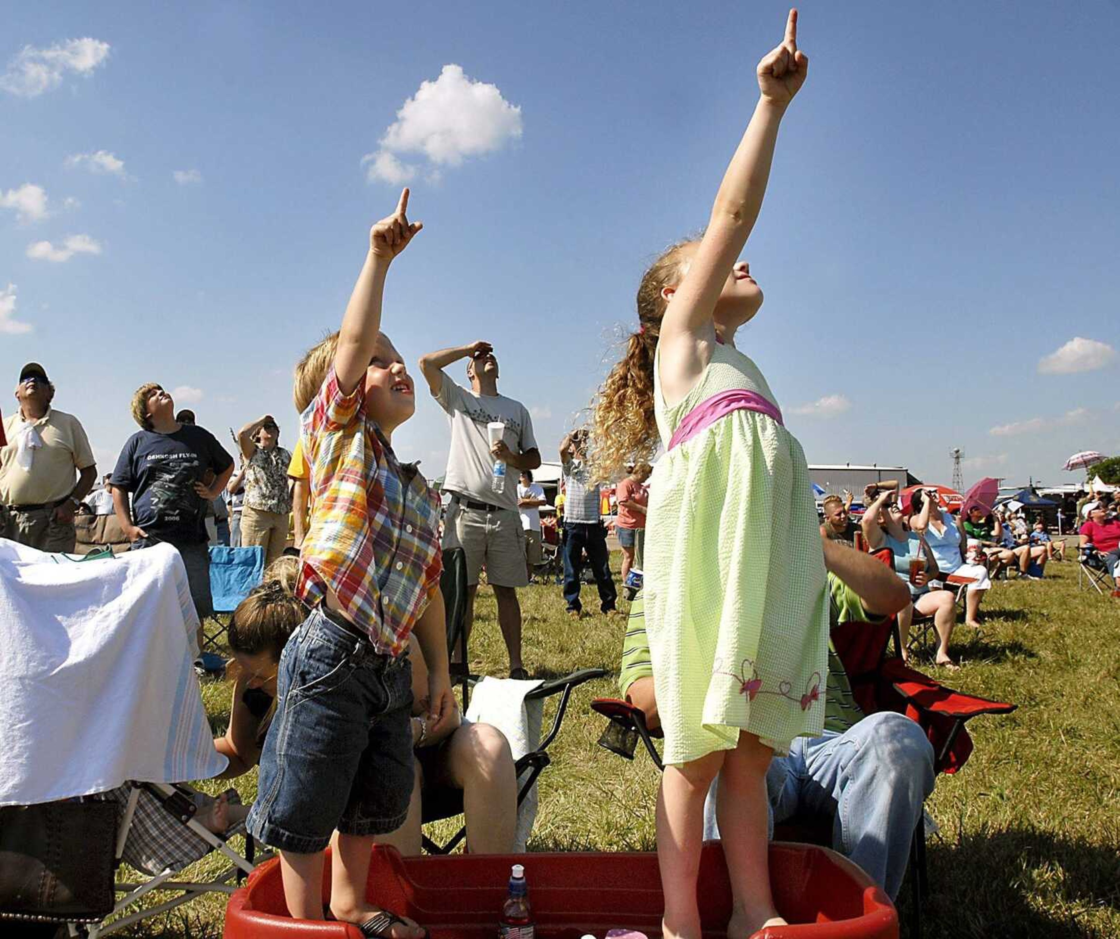 In this file photo, siblings Tanner Mitchell, 3, and Shaunna Mitchell, 6, kept track of Cape Girardeau Regional Air Festival's Skip Stewart while perched atop their red Radio Flyer wagon on Saturday, July 7, 2007. (Kit Doyle)