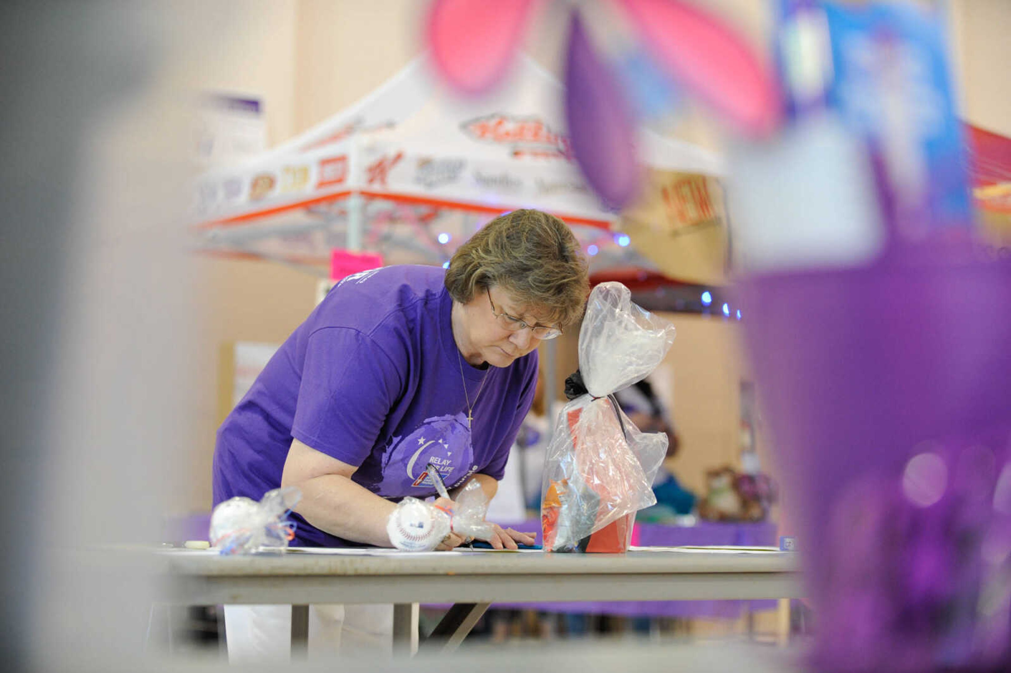 GLENN LANDBERG ~ glandberg@semissourian.com


Dolores Bohnsack places a bid during a silent auction at the Relay for Life of Cape Girardeau County fundraiser in the Osage Centre, Saturday, May 7, 2016.