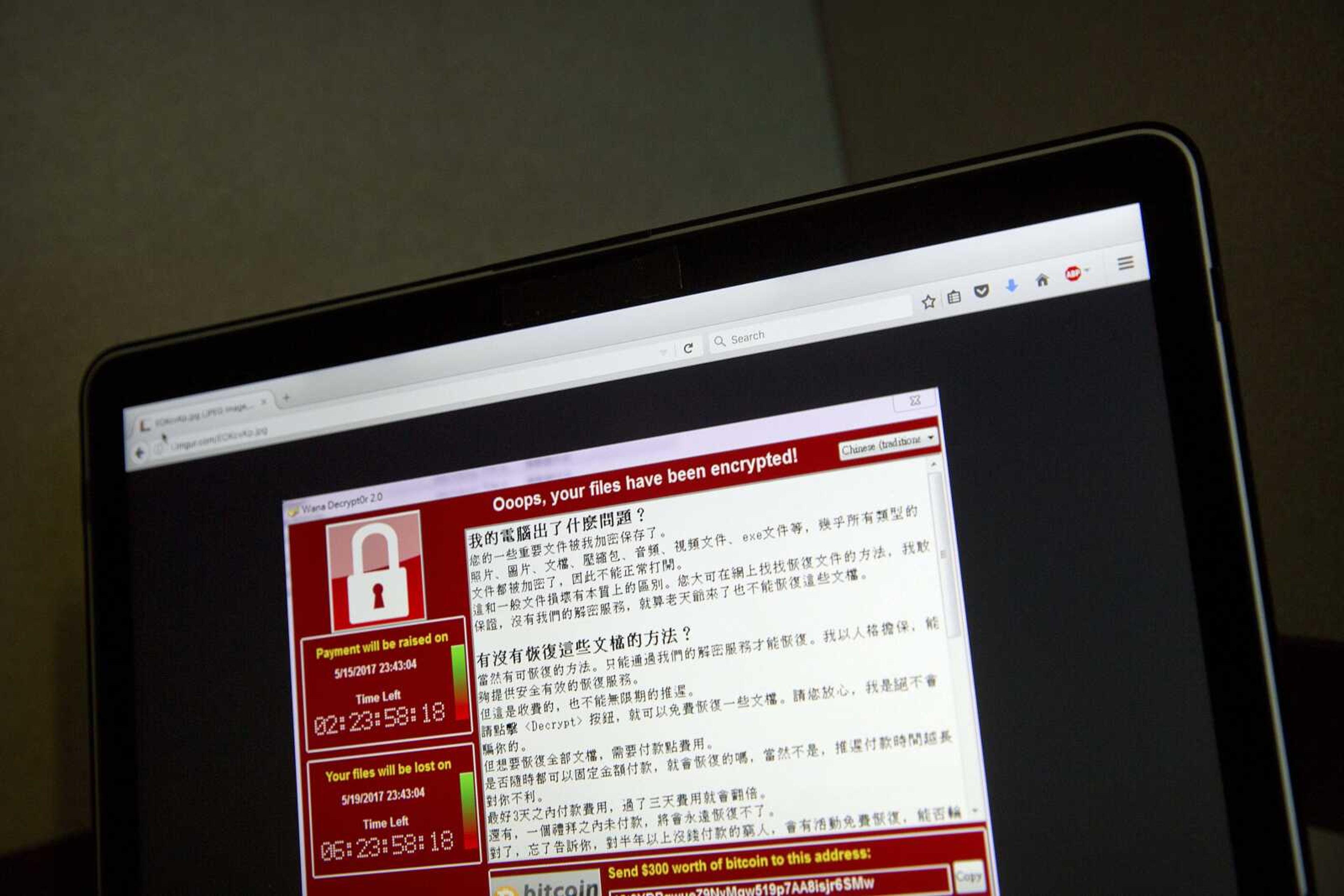 A screenshot of the warning screen from a purported ransomware attack, as captured by a computer user in Taiwan, is seen Saturday on a laptop in Beijing. Dozens of countries were hit with a huge cyberextortion attack Friday that locked up computers and held users' files for ransom.