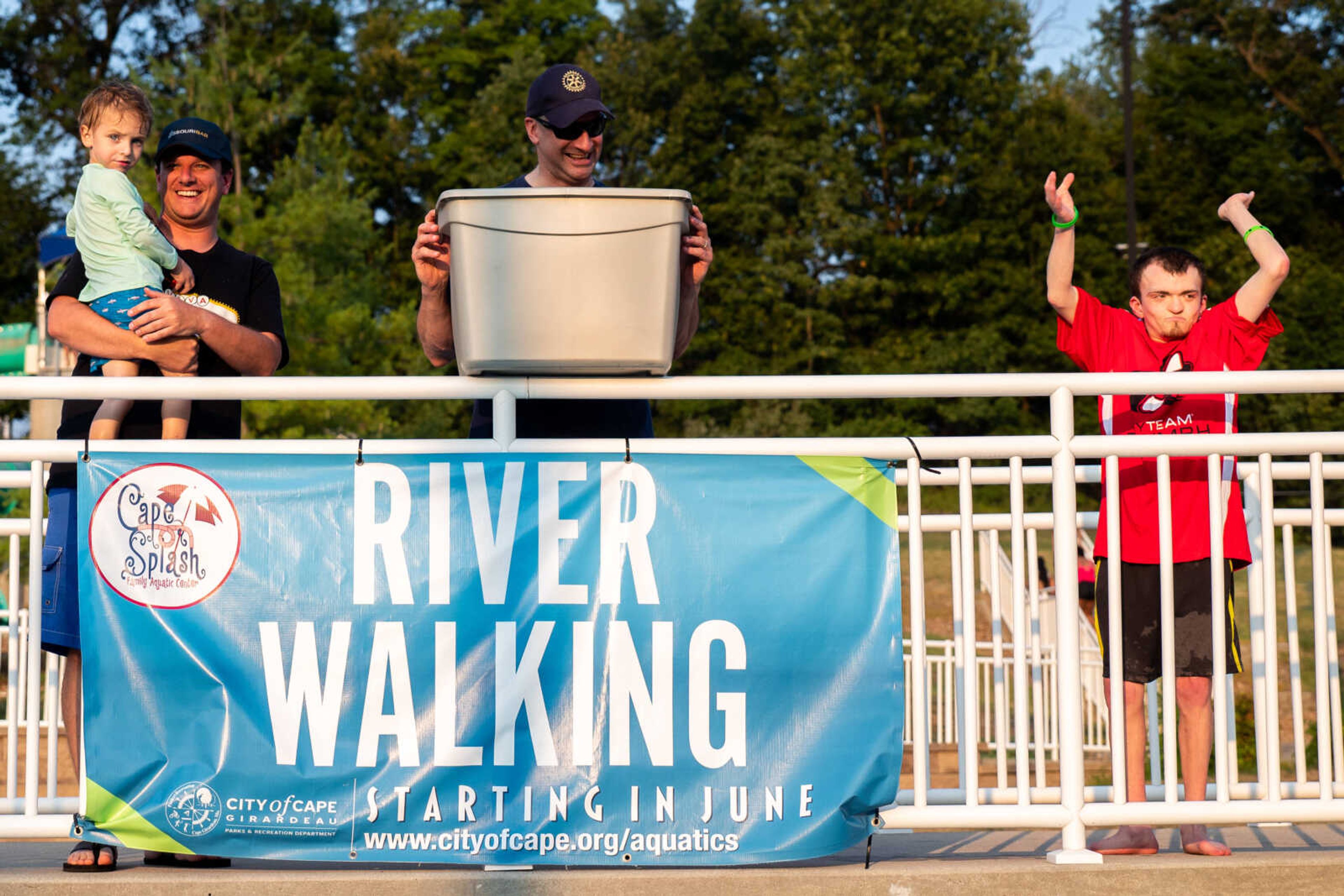 Mark Welker, Oliver Welker, Scott McClanahan and Hunter Ross prepare to dump the rubber ducks into the lazy river during the Duck Regatta.