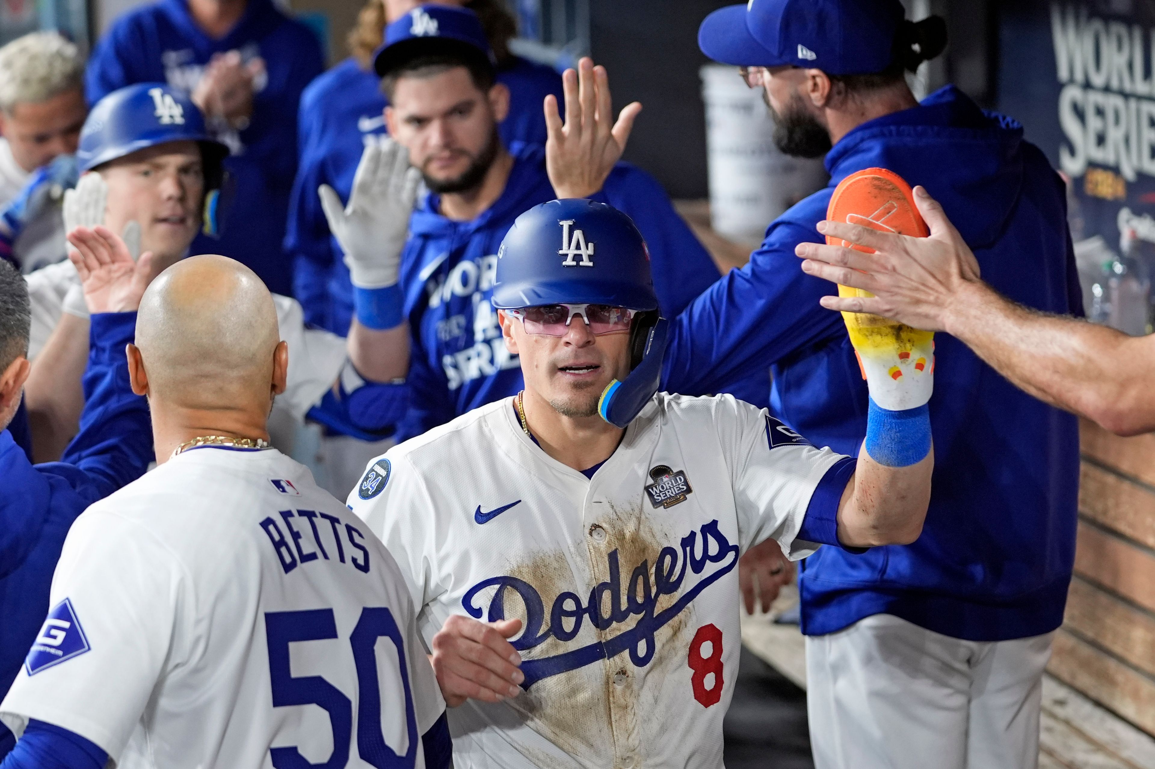 Los Angeles Dodgers' KikéHernández (8) celebrates in the dugout after scoring against the New York Yankees during the fifth inning in Game 1 of the baseball World Series, Friday, Oct. 25, 2024, in Los Angeles. (AP Photo/Godofredo A. Vásquez)