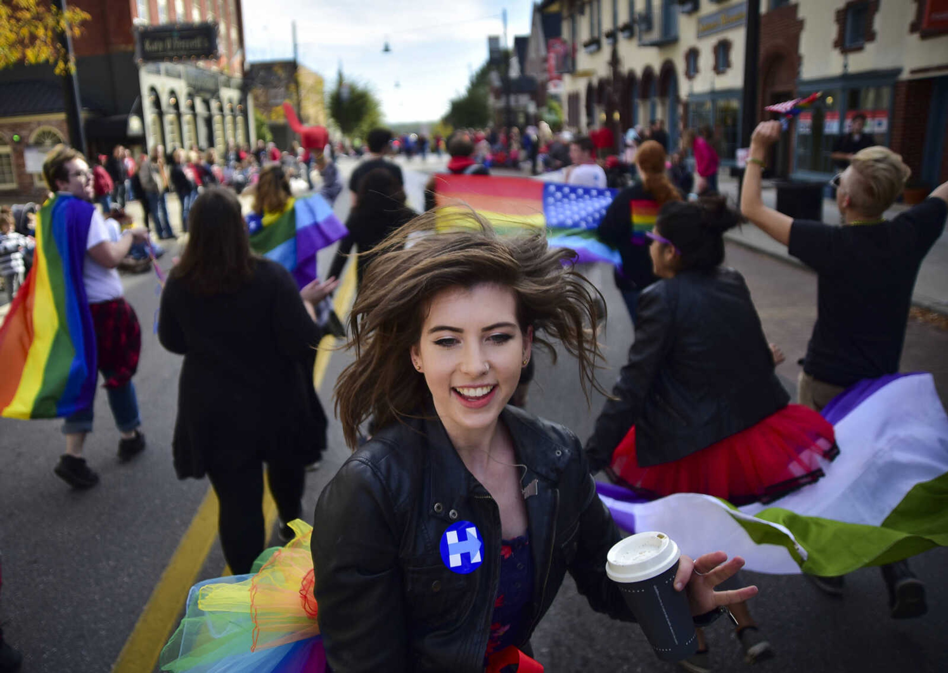 ANDREW J. WHITAKER ~ awhitaker@semissourian.com Jenn Meyer with the Semo LGBT Community march down Broadway during the Southeast Missouri State University homecoming parade Saturday, Nov. 5, 2016 in Cape Girardeau.