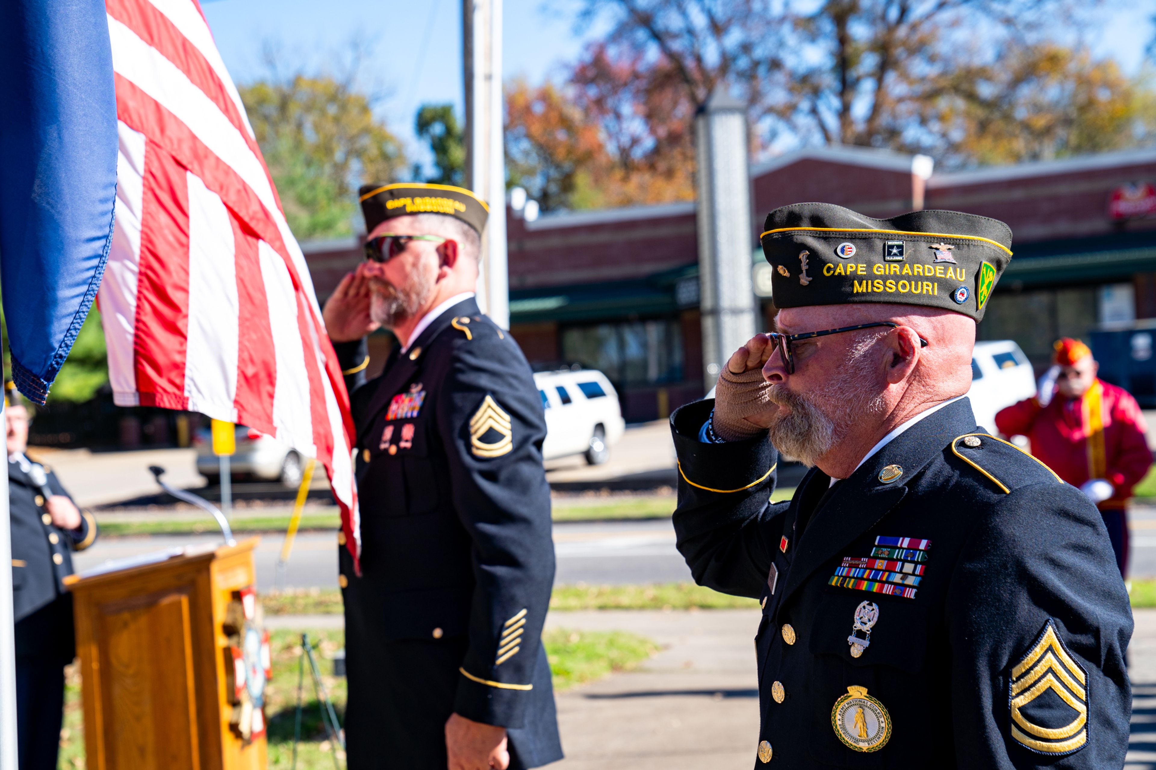 Color guard members salute toward flags after they are presented during a Veterans Day ceremony at Capaha Park on Monday, Nov. 11, in Cape Girardeau.