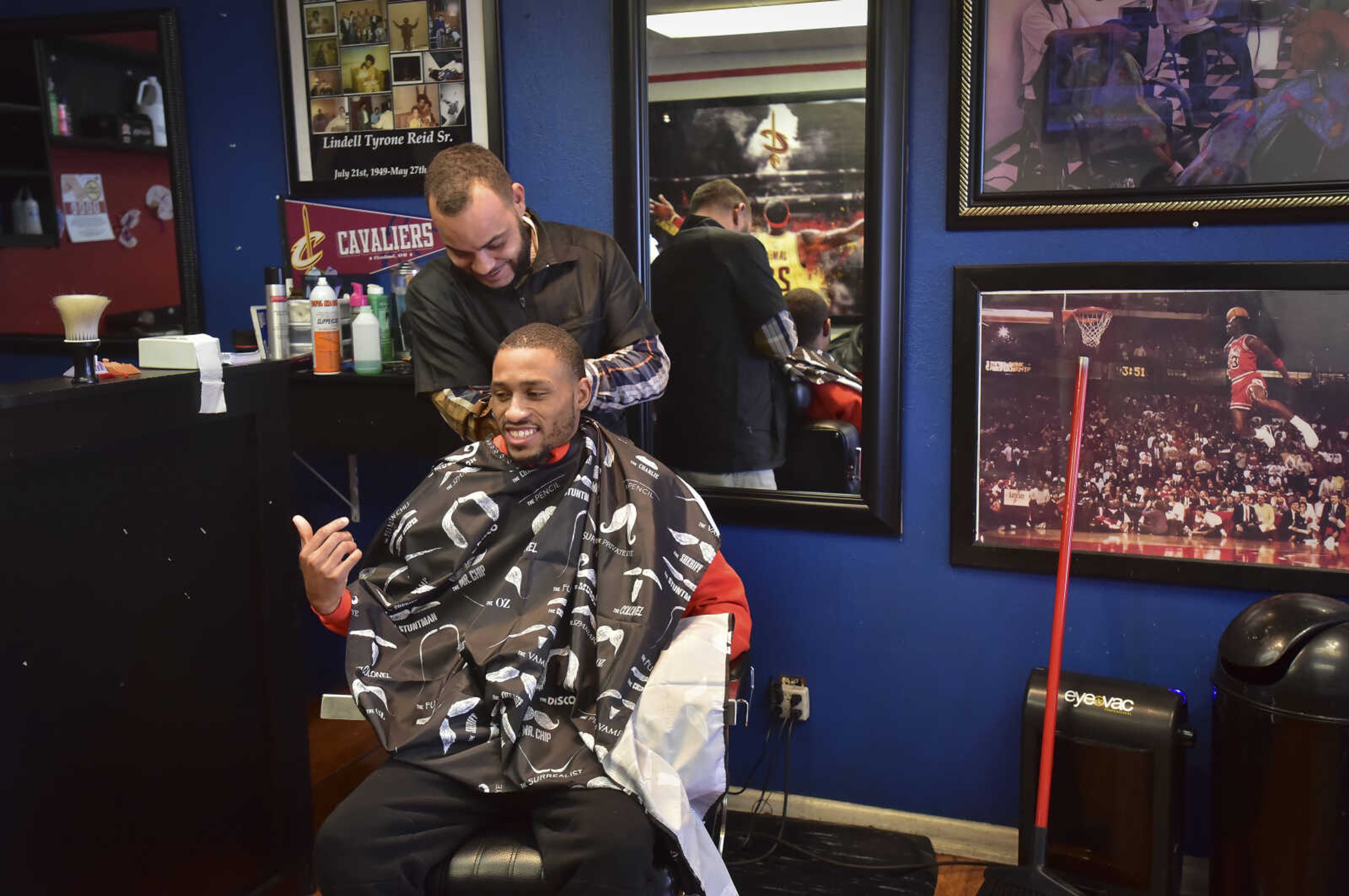 Quinton Davis talks and laughs with Chuck Reid as gets his hair cut at The Shop Friday, Jan. 6, 2017 at 821 Broadway in Cape Girardeau.