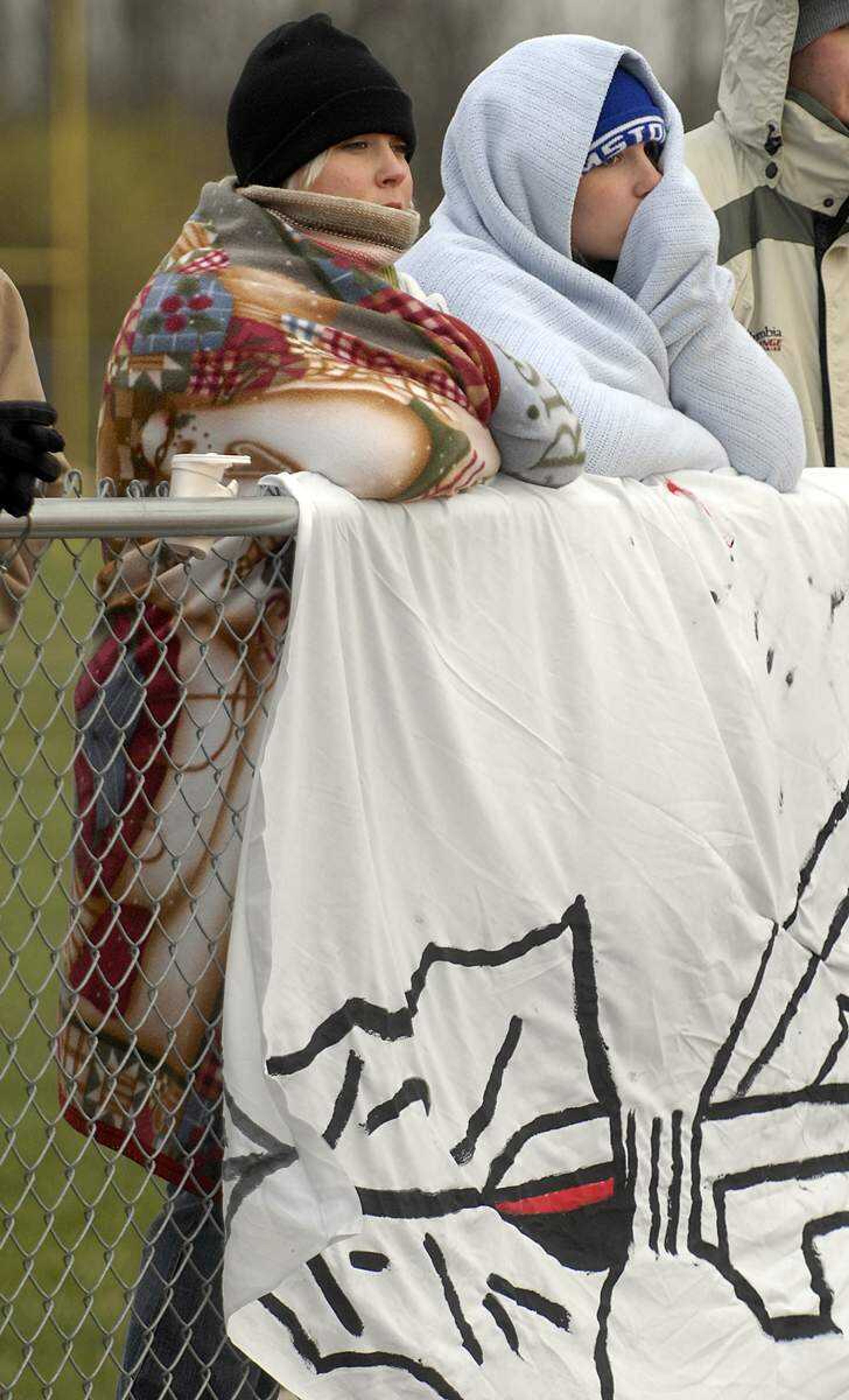 ELIZABETH DODD ~ edodd@semissourian.com
Jackson fans Tayler Meyer, left, and her sister, Alyssa Meyer, attempt to stay warm while watching the game.