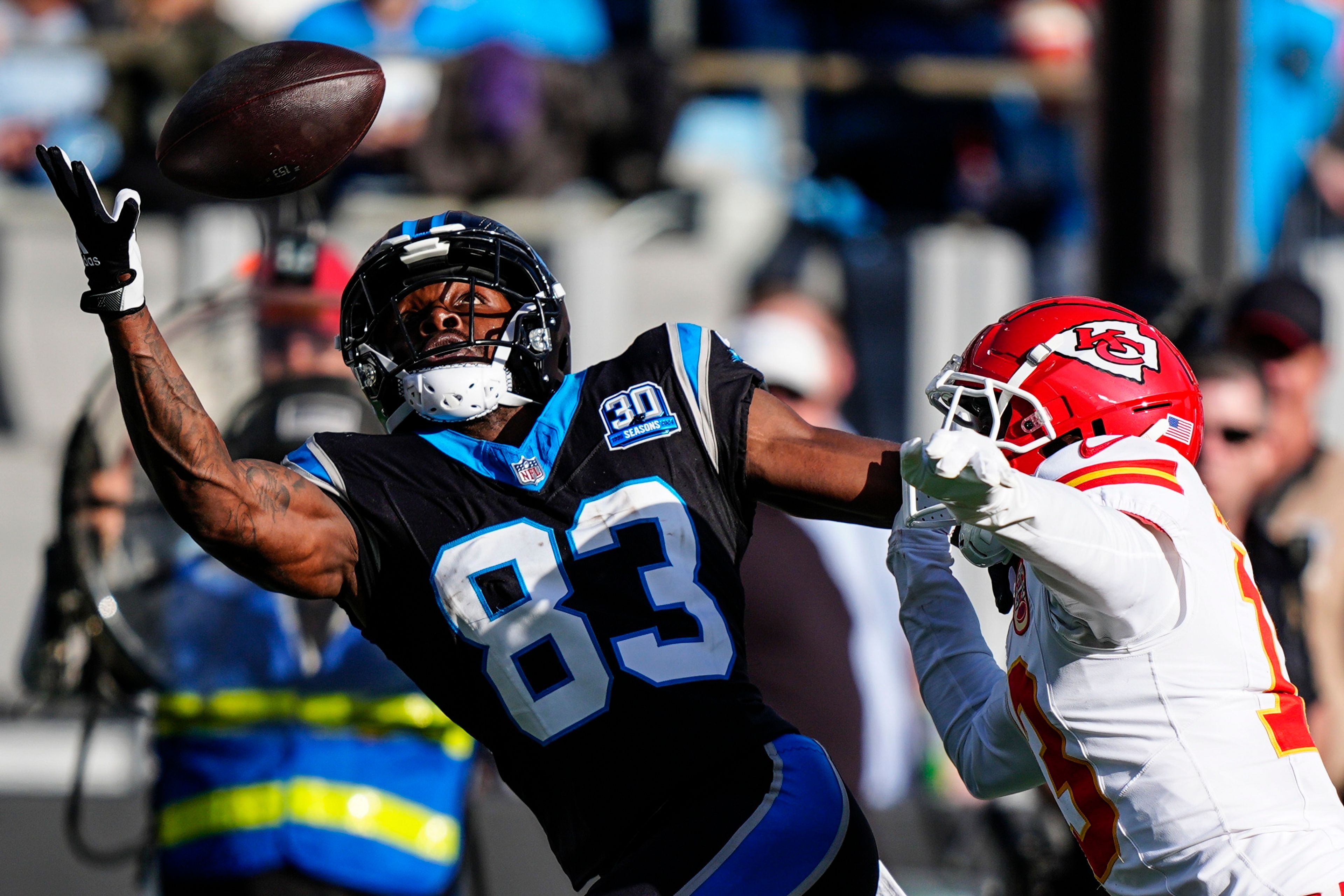 Carolina Panthers wide receiver David Moore (83) works for a catch against Kansas City Chiefs safety Nazeeh Johnson (13) during the second half of an NFL football game, Sunday, Nov. 24, 2024, in Charlotte, N.C. (AP Photo/Jacob Kupferman)