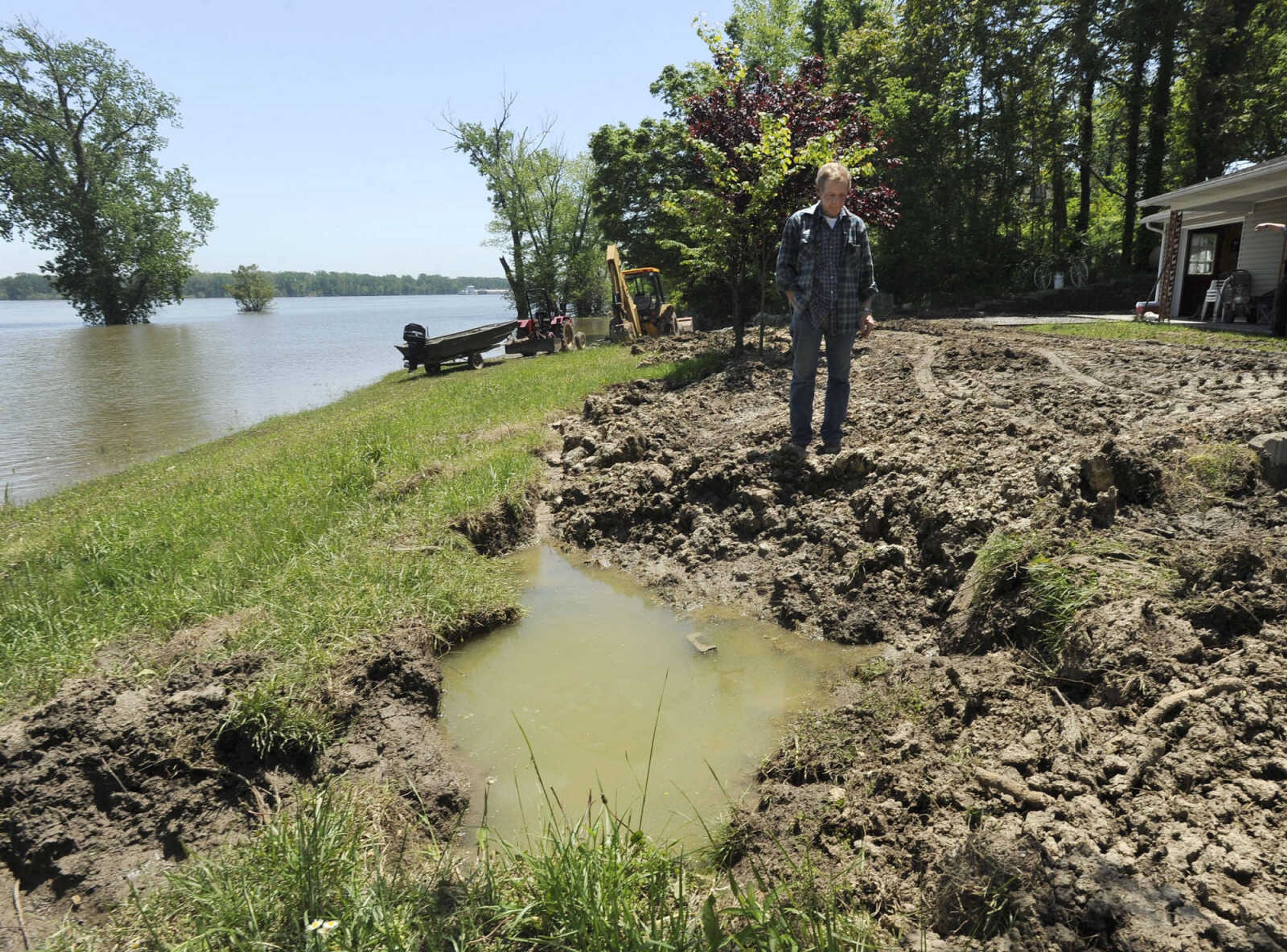 FRED LYNCH ~ flynch@semissourian.com
Darriel Williams of Commerce, Mo. stands in his back yard next to the Mississippi River Sunday, May 8, 2011. He is leveling the levee he built as a precaution which he did not need after all.