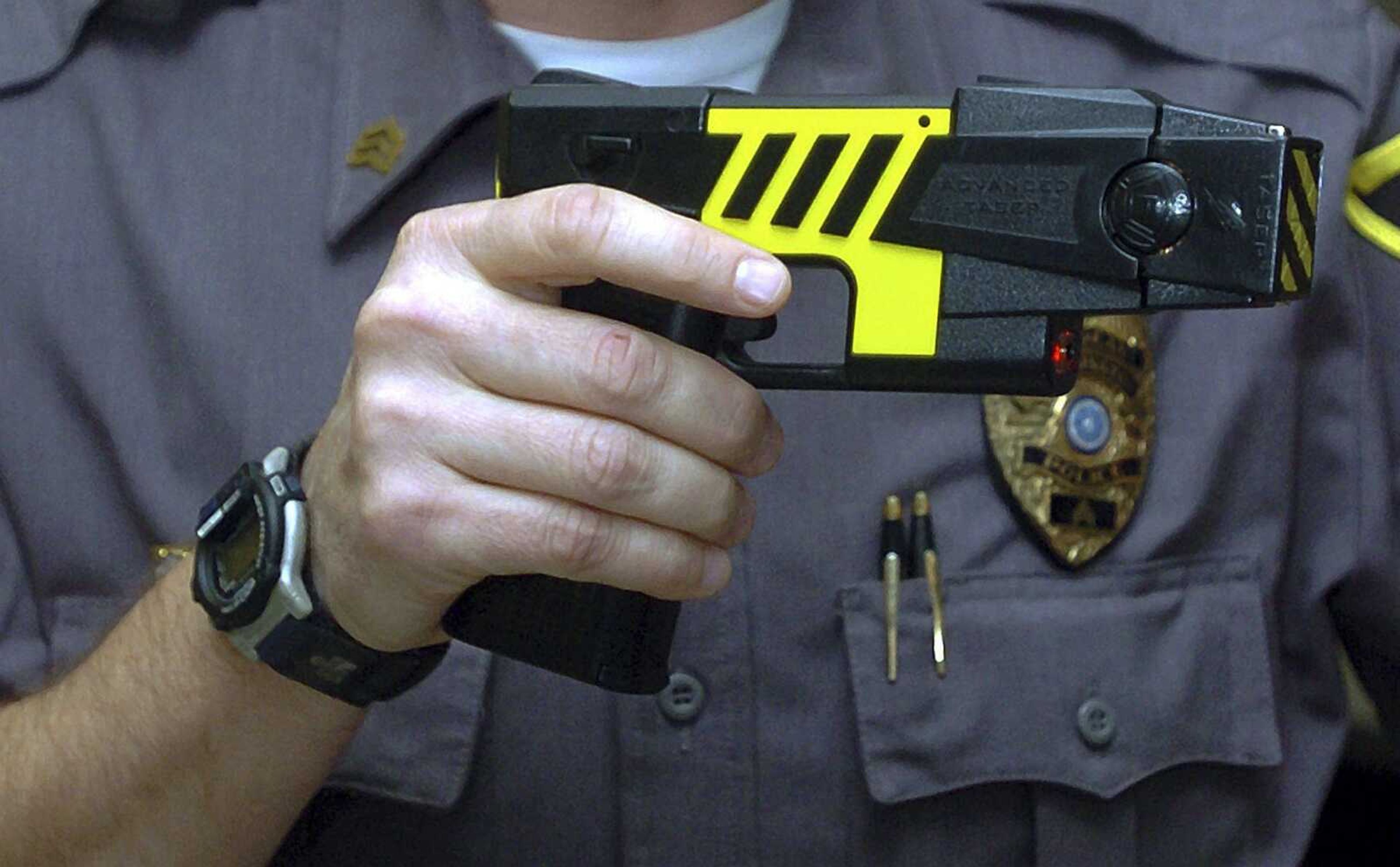 An officer holds a stun gun used by his police department in a Farmington, Connecticut.