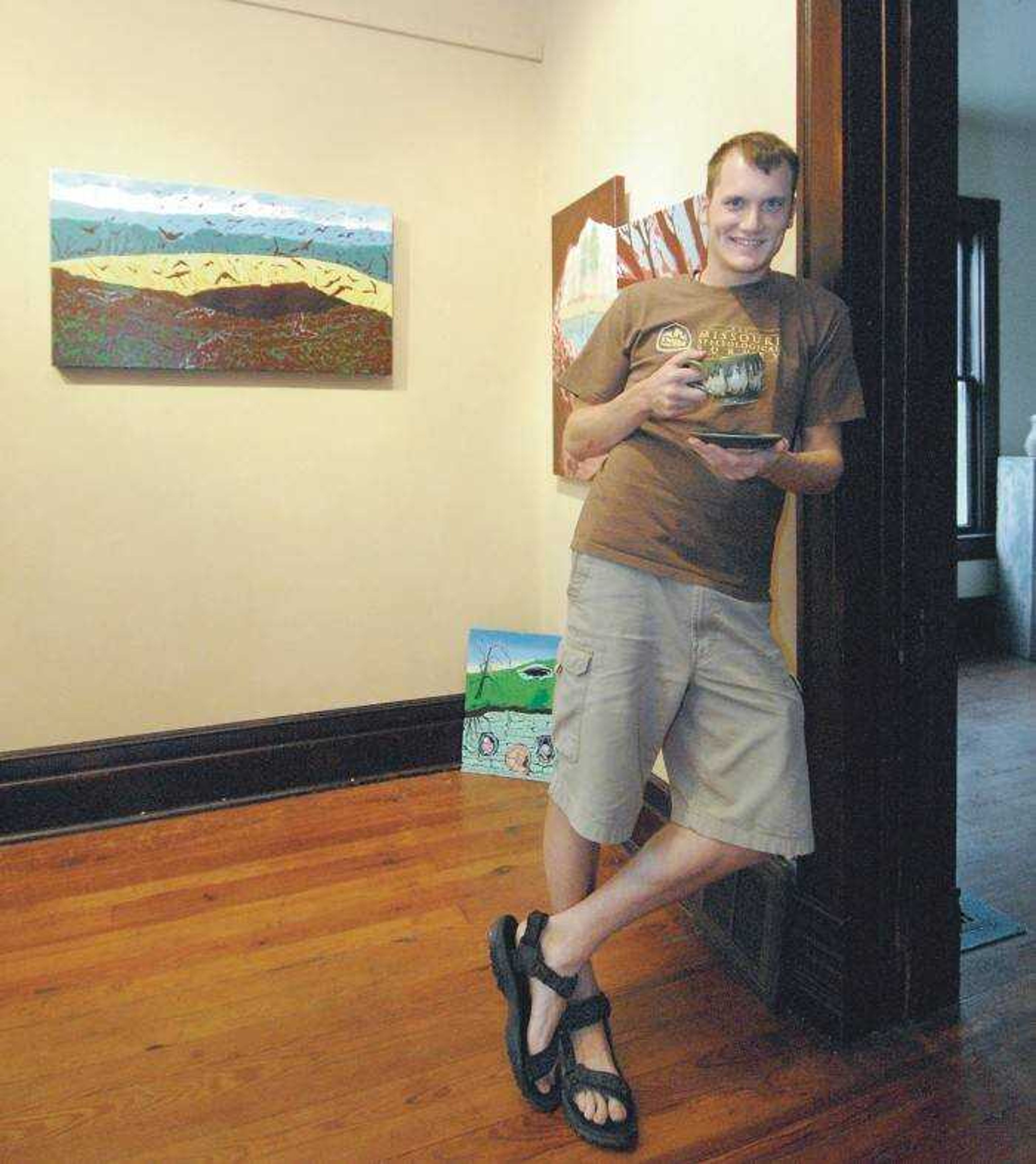 Local artist Jake Wells was surrounded by some of his recent work at the Fountain Street Gallery in Cape Girardeau. (Don Frazier)