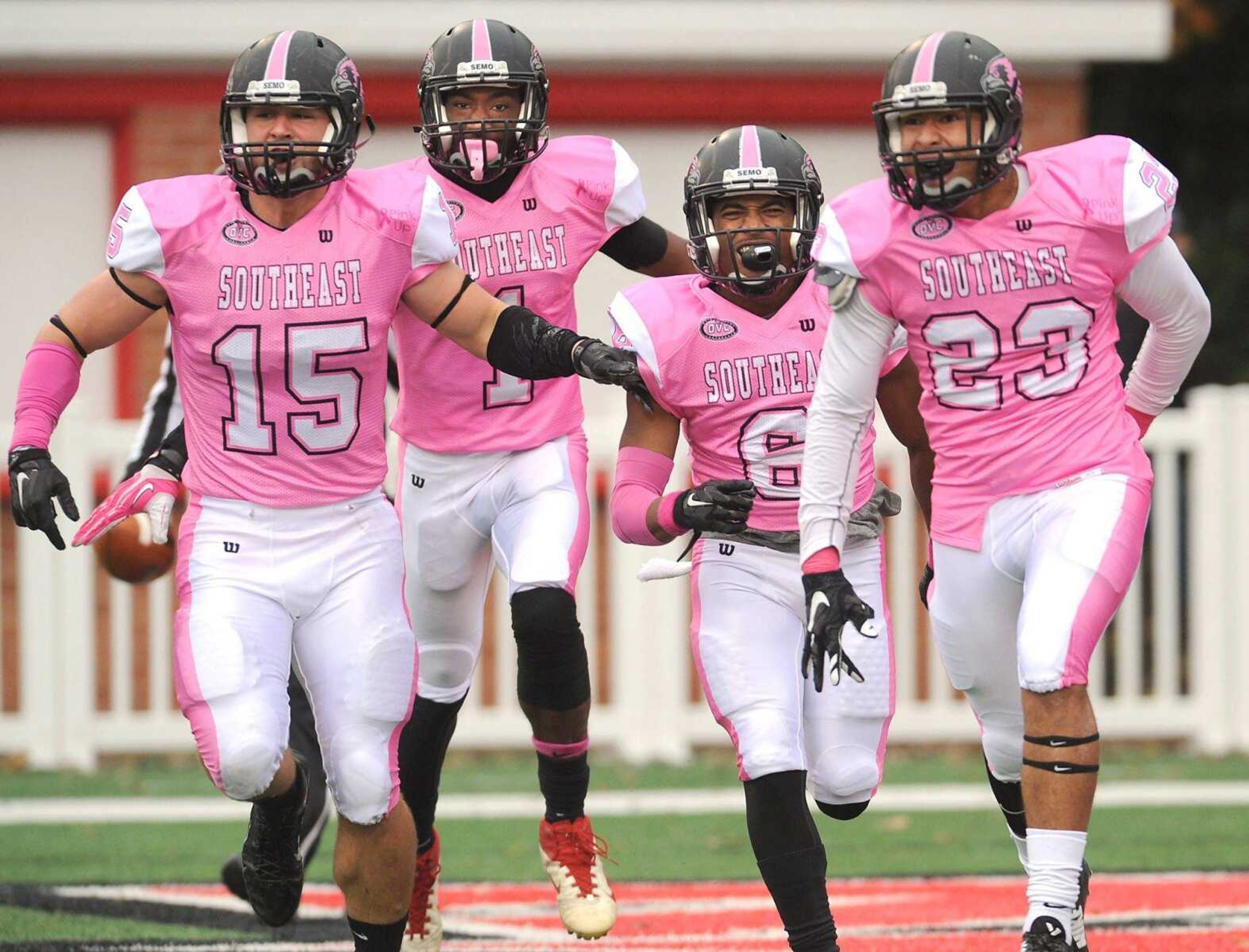 Southeast Missouri State's Brad Ivey, left, Paul McRoberts, Darrius Darden-Box and Josh Kinzer run off the field after celebrating a blocked punt and recovery for a touchdown against Tennessee Tech during the third quarter Saturday at Houck Stadium. (Fred Lynch)