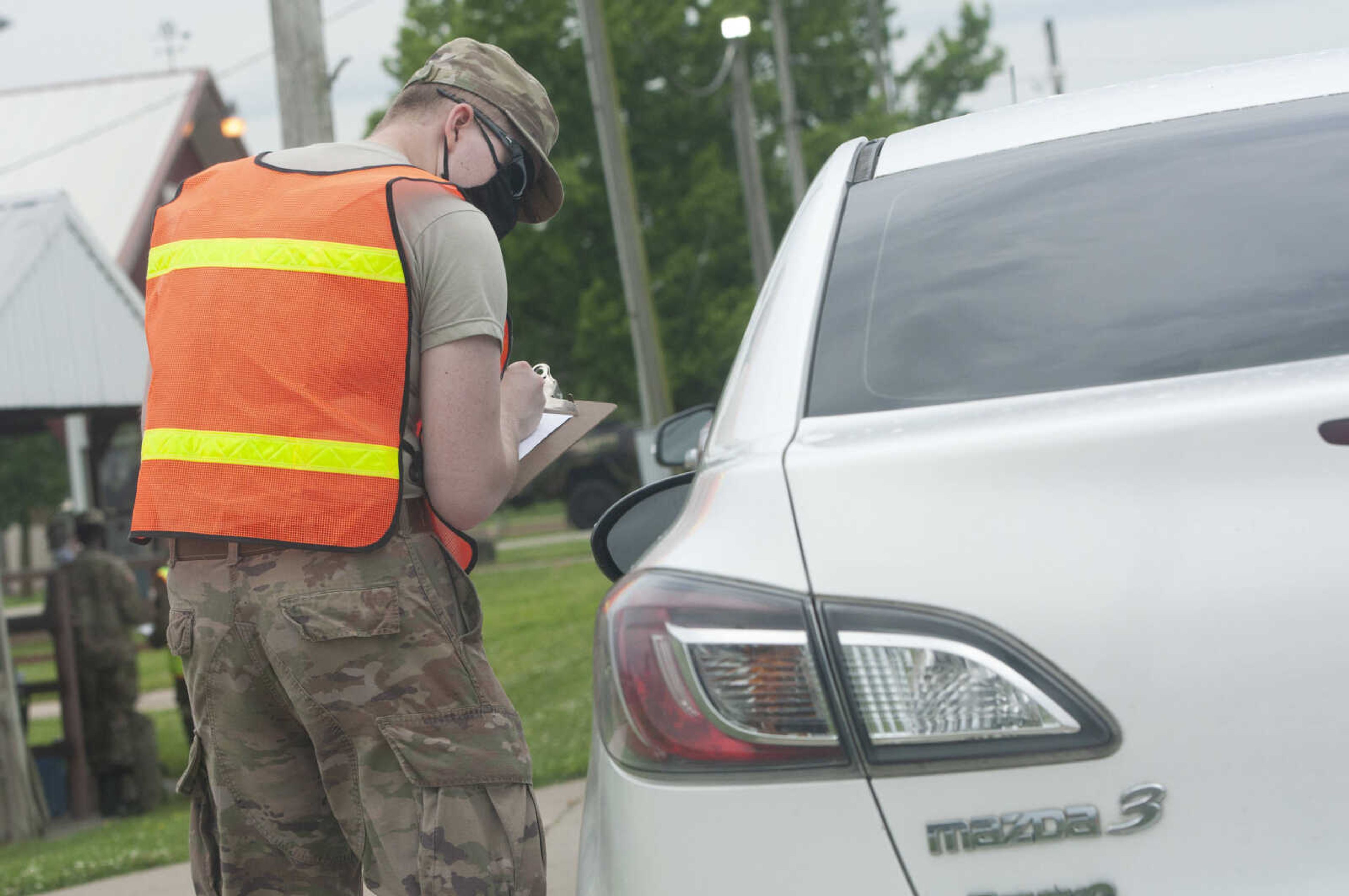 A COVID-19 testing site worker speaks with a person in line for free COVID-19 testing Friday, June 5, 2020, at Arena Park in Cape Girardeau. The drive-through testing event was scheduled for 7 a.m. to 7 p.m.