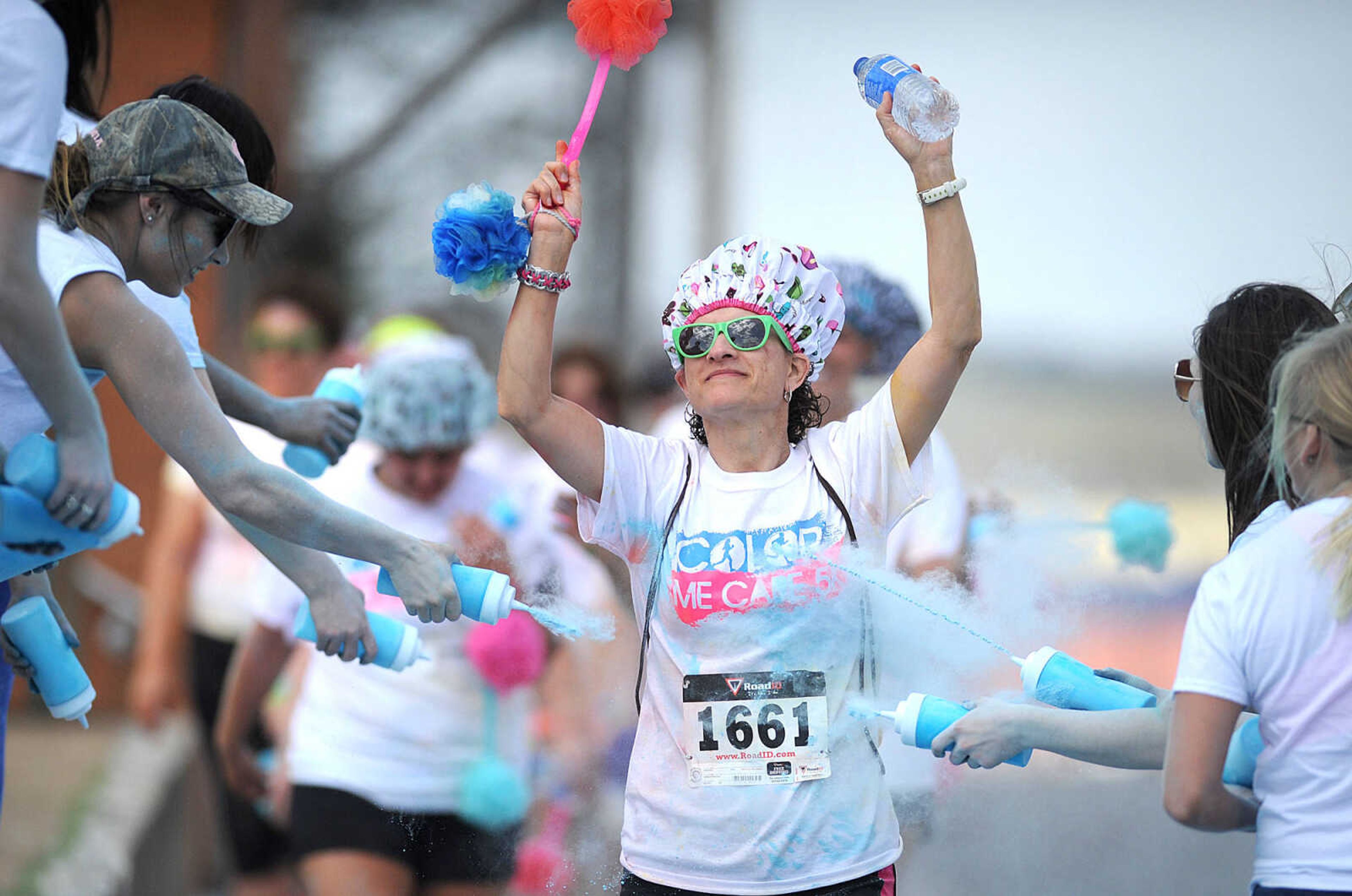 LAURA SIMON ~ lsimon@semissourian.com

Participants in the Color Me Cape 5K are sprayed with blue powder at the final color station on Main Street, Saturday, April 12, 2014, in Cape Girardeau.