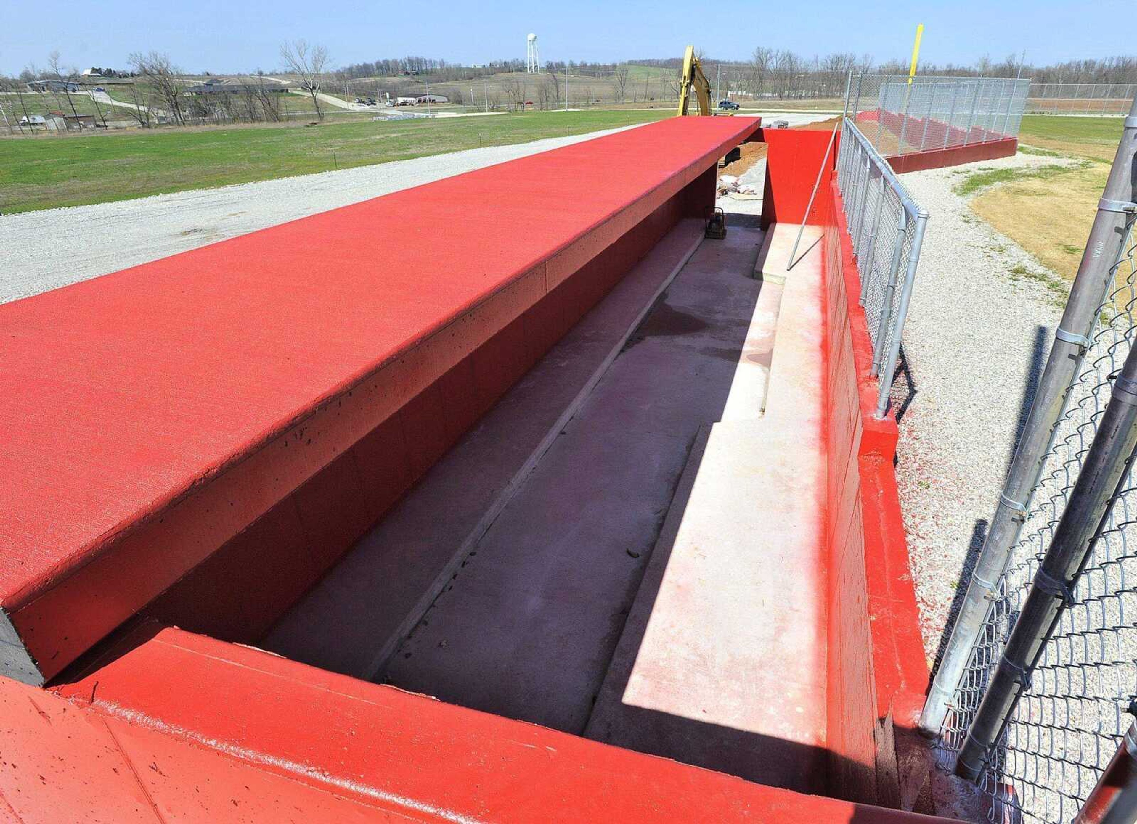 The home team dugout at Whitey Herzog Stadium in Jackson has a sloped floor for water drainage.