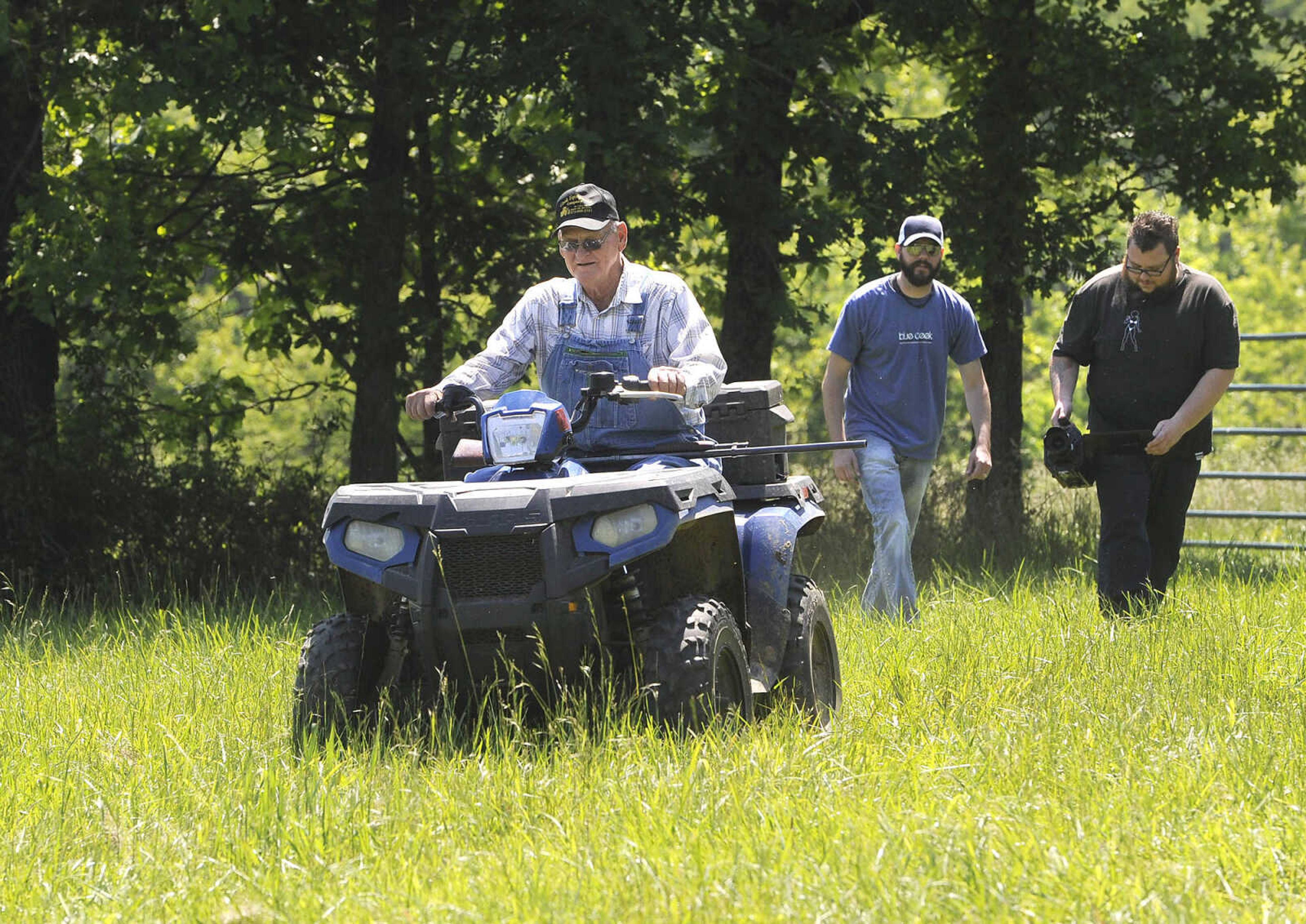 FRED LYNCH ~ flynch@semissourian.com
Bill Fulton enters the scene on his four-wheeler as Dustin Bannister, owner of Blue Creek Production, and visual director Thomas Walton follow the action for The Hollerboys video at Fulton's farm Sunday, May 22, 2016 near Patton, Missouri.