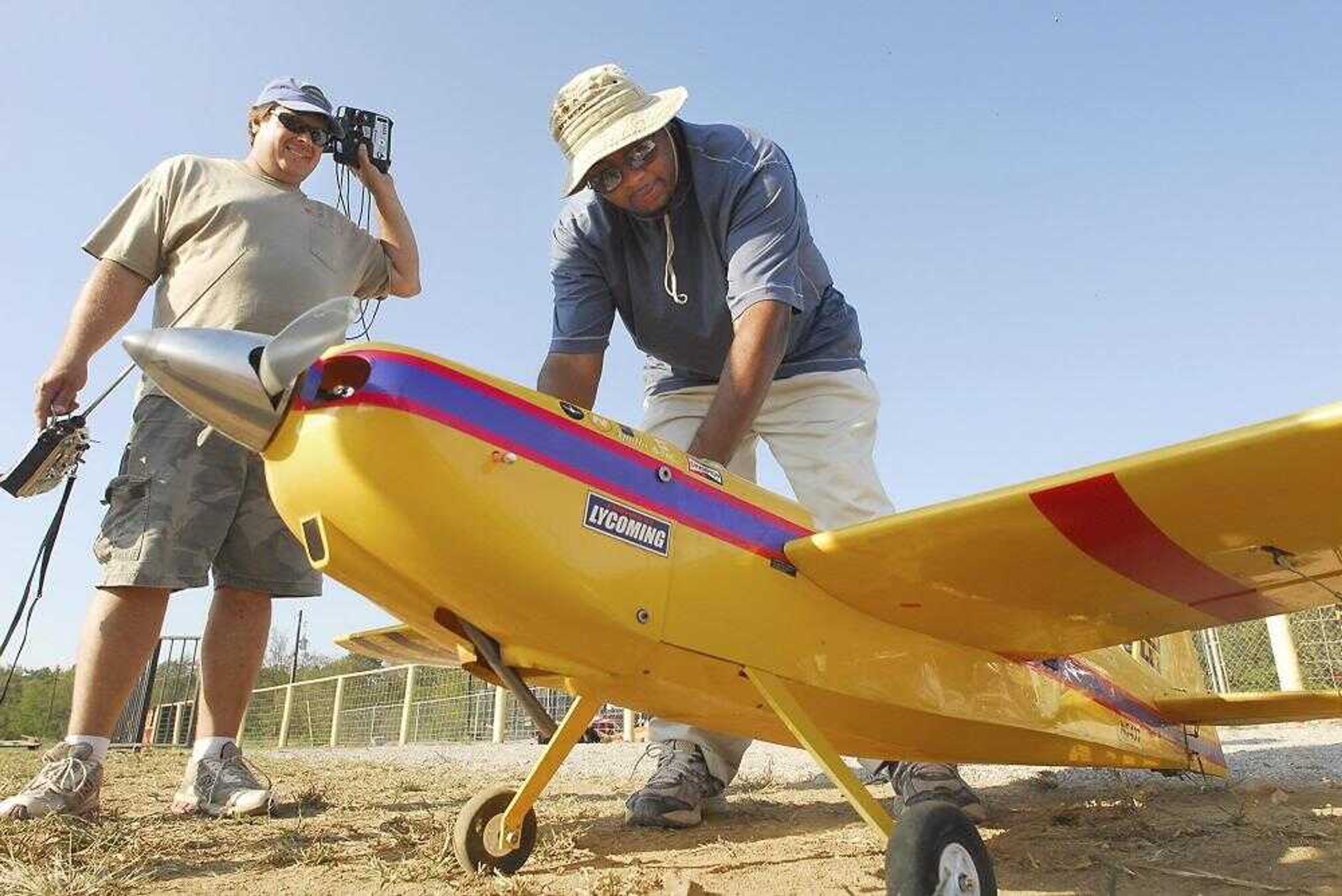 Dr. Frank Hayward prepared his Edge 540 model aircraft for flight as Daryl Baremore watched Sunday at the Galaxy Park Model Airfield north of Cape Girardeau.<br>FRED LYNCH <br>flynch@semissourian.com