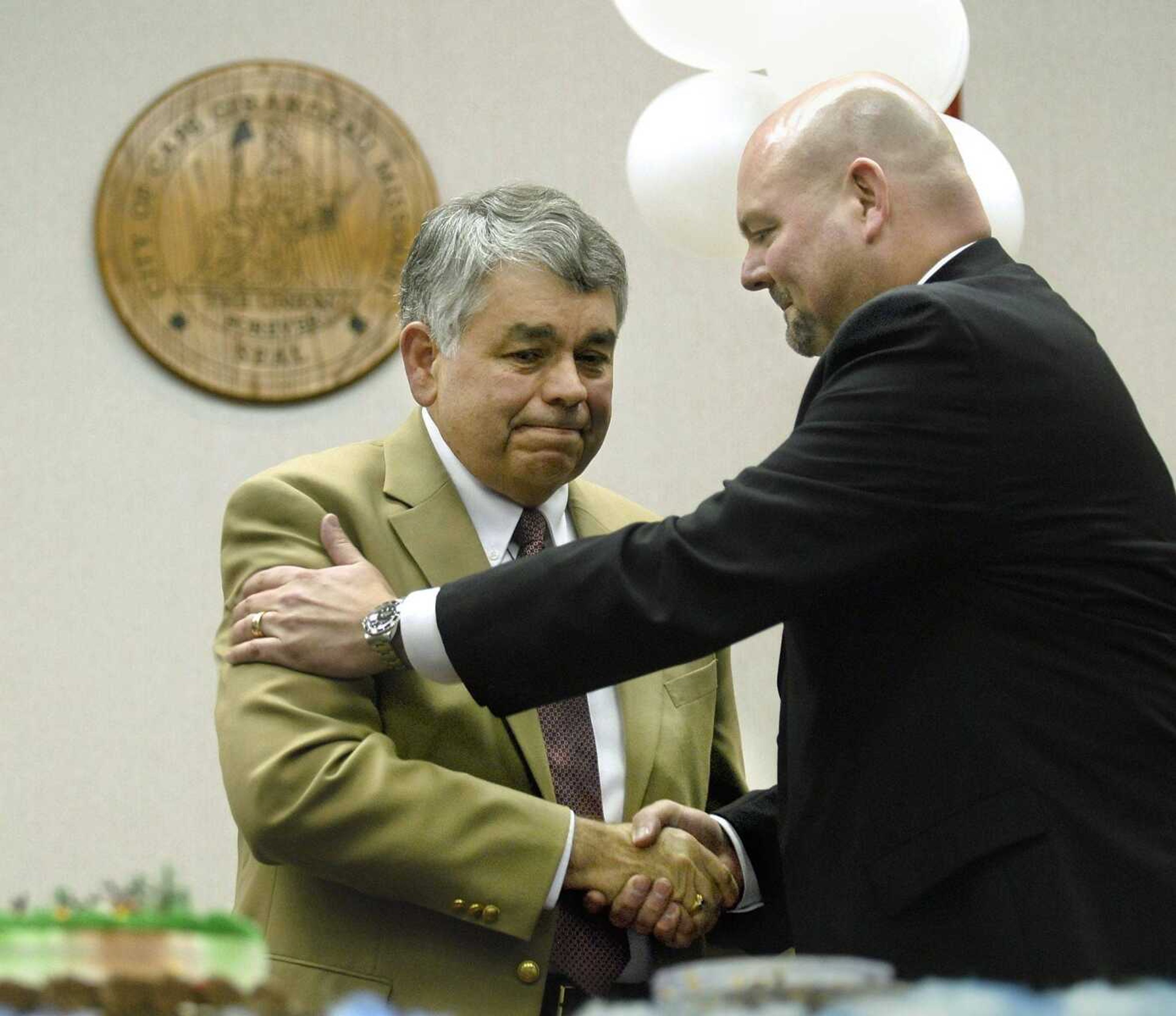 Doug Leslie tears up while shaking hands with Mayor Jay Knudtson while Leslie receives a standing ovation at his retirement party in February celebrating his time as city manager and working for the city of Cape Girardeau for 19 years. (Elizabeth Dodd)