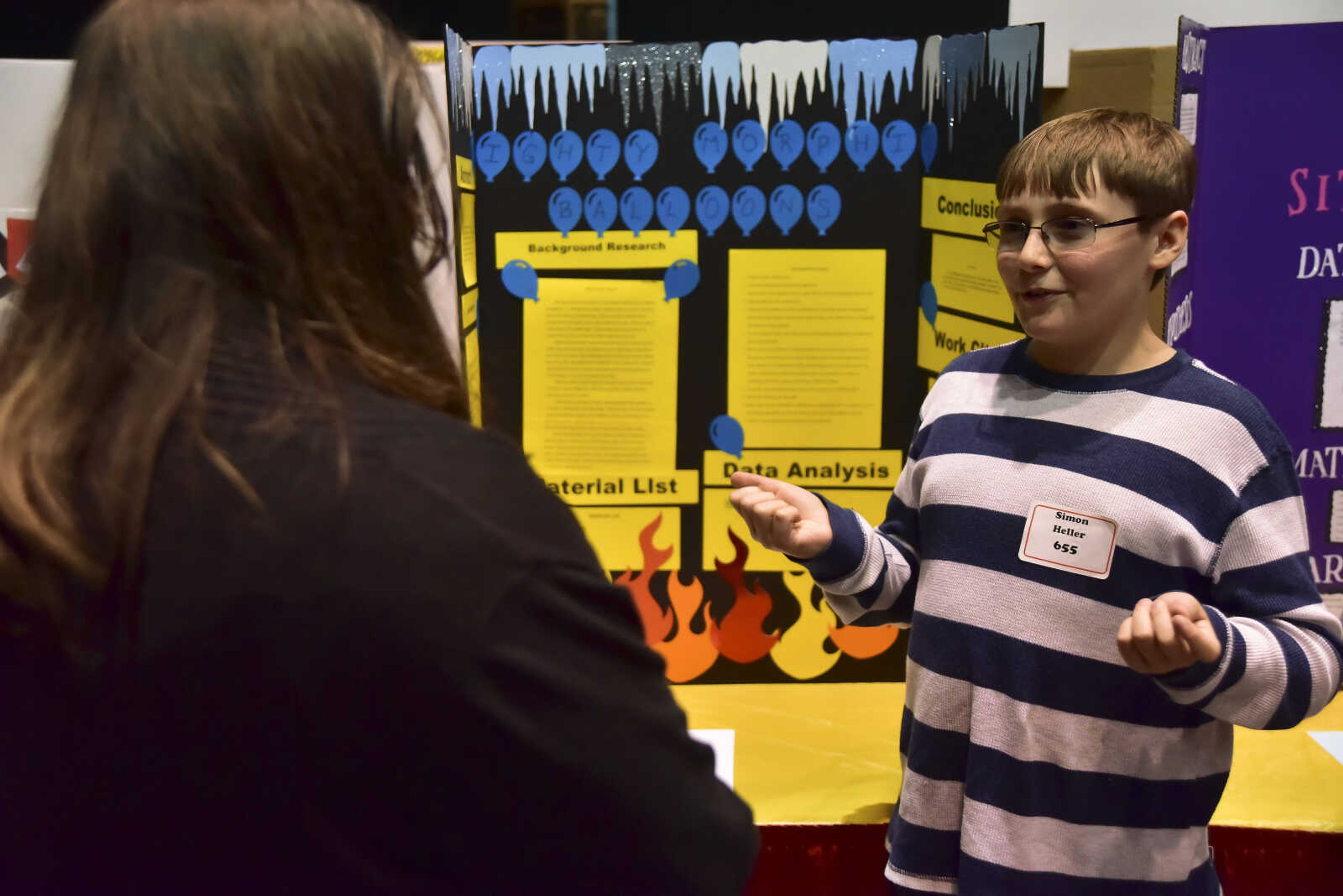 Simon Heller, right, talks about his project during the Southeast Missouri Regional Science Fair Tuesday, March 7, 2017 at the Show Me Center in Cape Girardeau.