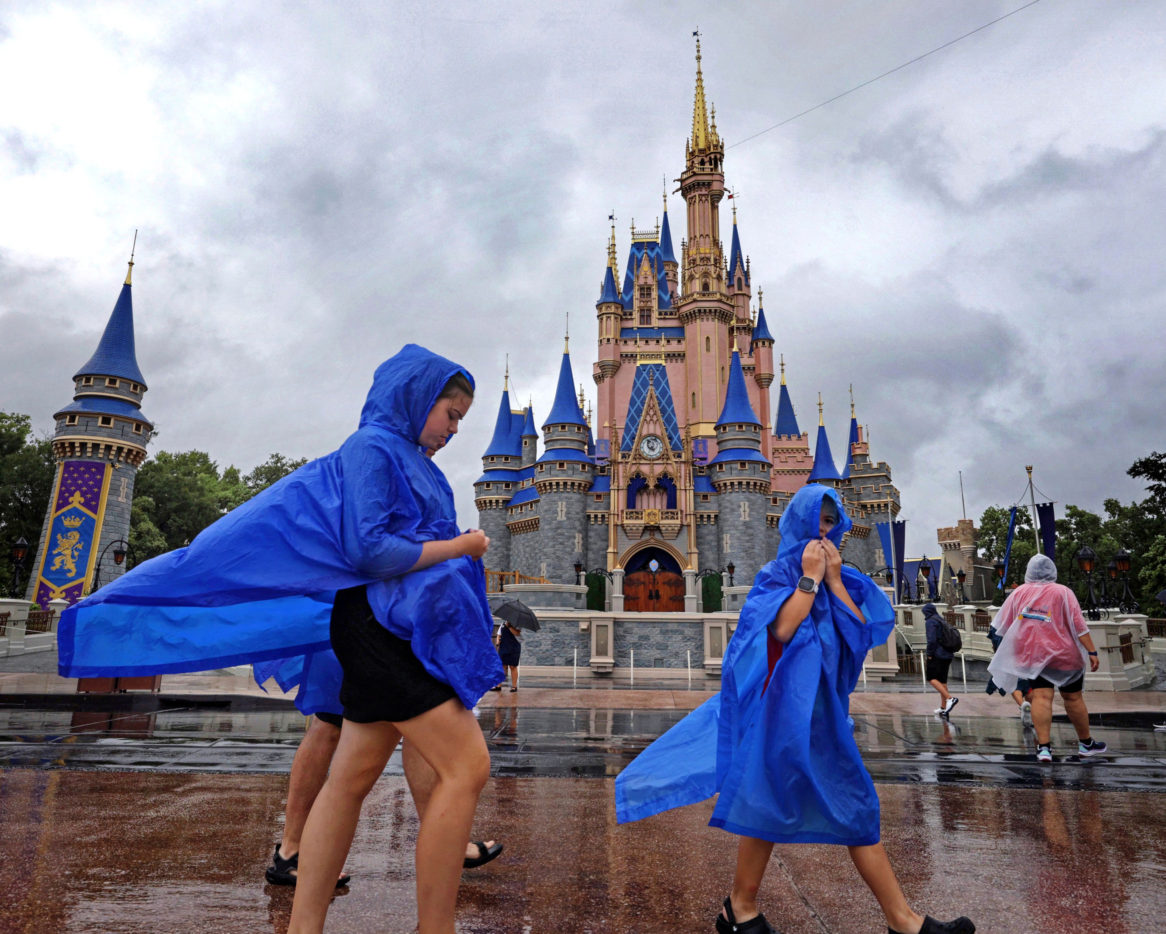 FILE - Guests at the Magic Kingdom at Walt Disney World brave wind and rain as bands of weather from Hurricane Debby pass through Central Florida, Aug. 5, 2024, in Bay Lake, Fla. (Joe Burbank/Orlando Sentinel via AP, file)