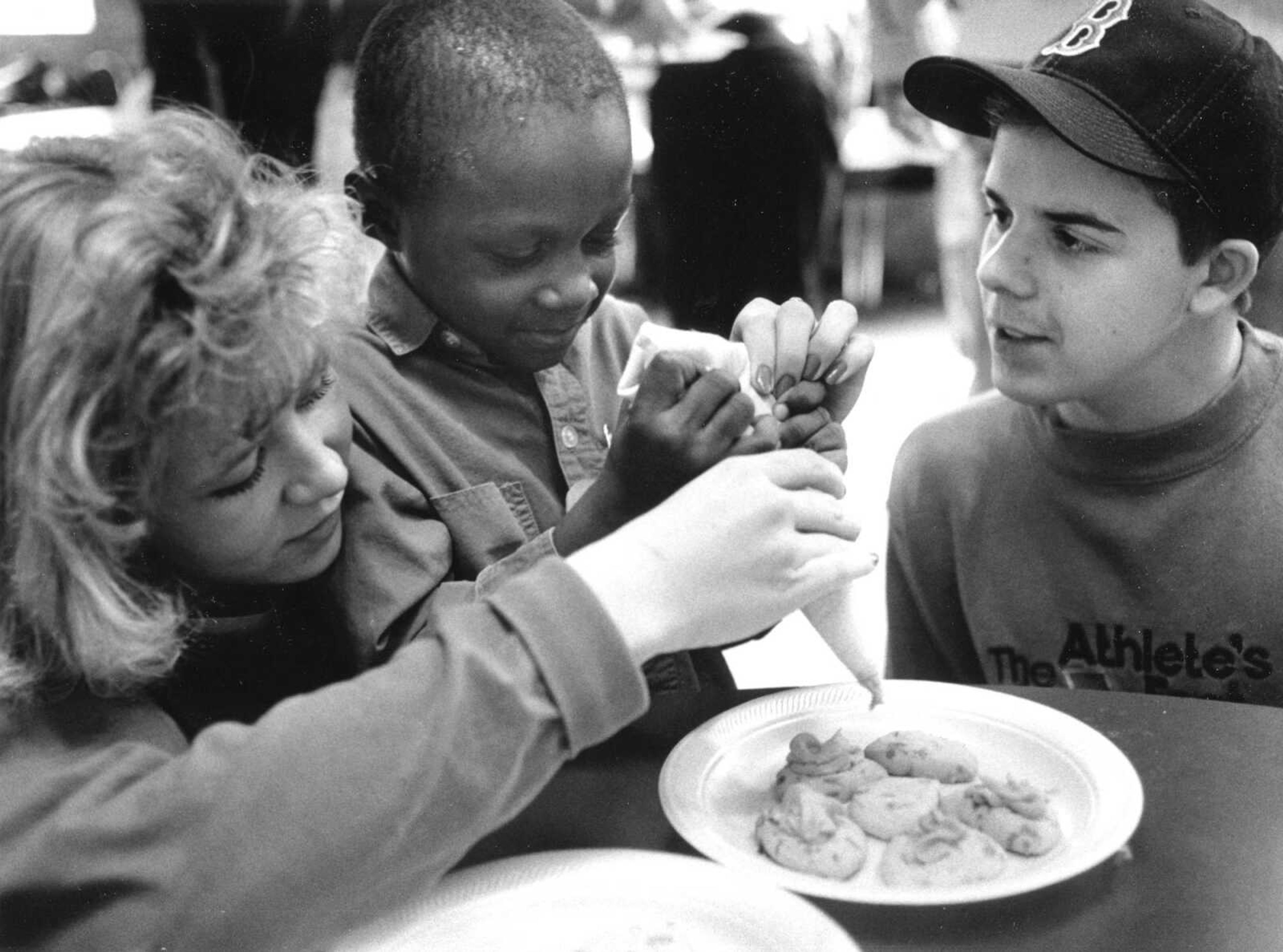 Published Feb. 23, 1992.
Terrance Smith decorated cookies with Southeast Missouri State University students Michelle Bridges and Chris Kappkier. Youngsters participating in the Cape Girardeau Head Start program visited with students from Southeast. (Southeast Missourian archive)