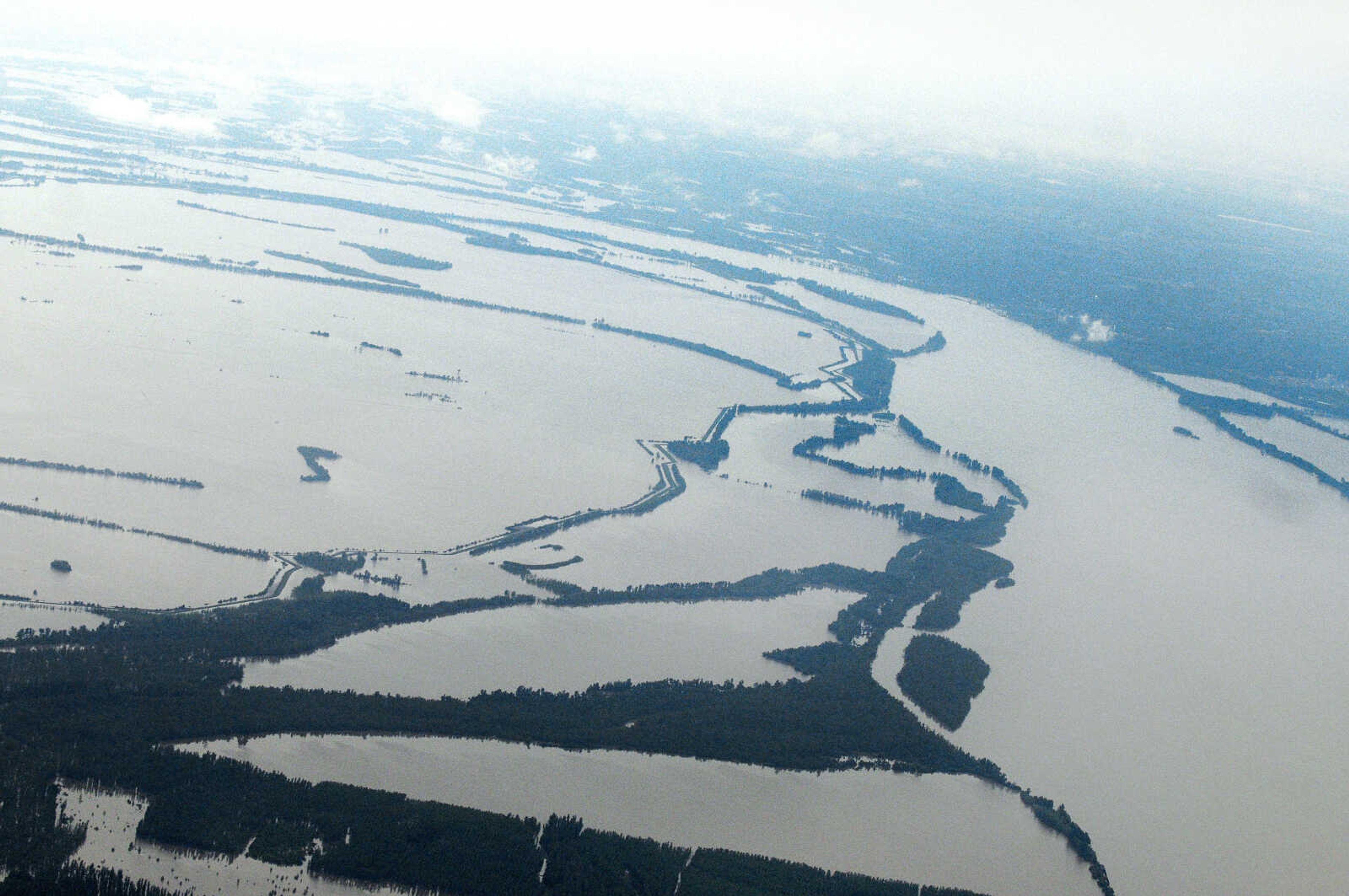 KRISTIN EBERTS ~ keberts@semissourian.com

Water from the Mississippi River, right, sweeps over the farmland in the Birds Point-New Madrid floodway, left, in Southeast Missouri on Tuesday, May 3, 2011. On May 2, Maj. Gen. Michael Walsh gave the order to intentionally breach the Birds Point levee, flooding over 130,000 acres of farmland to ease flooding upstream.