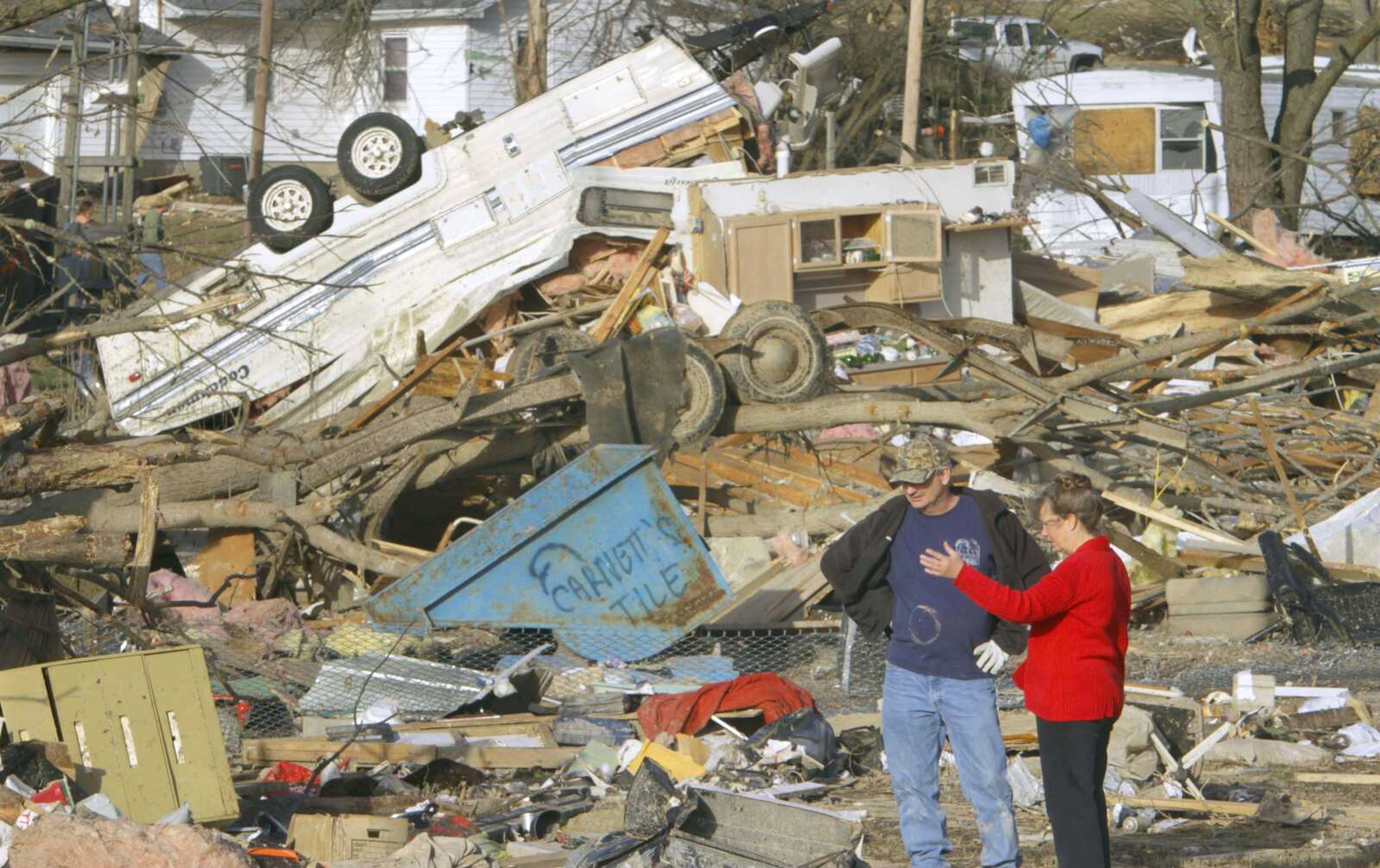 People try to salvage what they can Wednesday after a tornado destroyed homes in their neighborhood in Harrisburg, Ill.. (AP Photo/Seth Perlman)