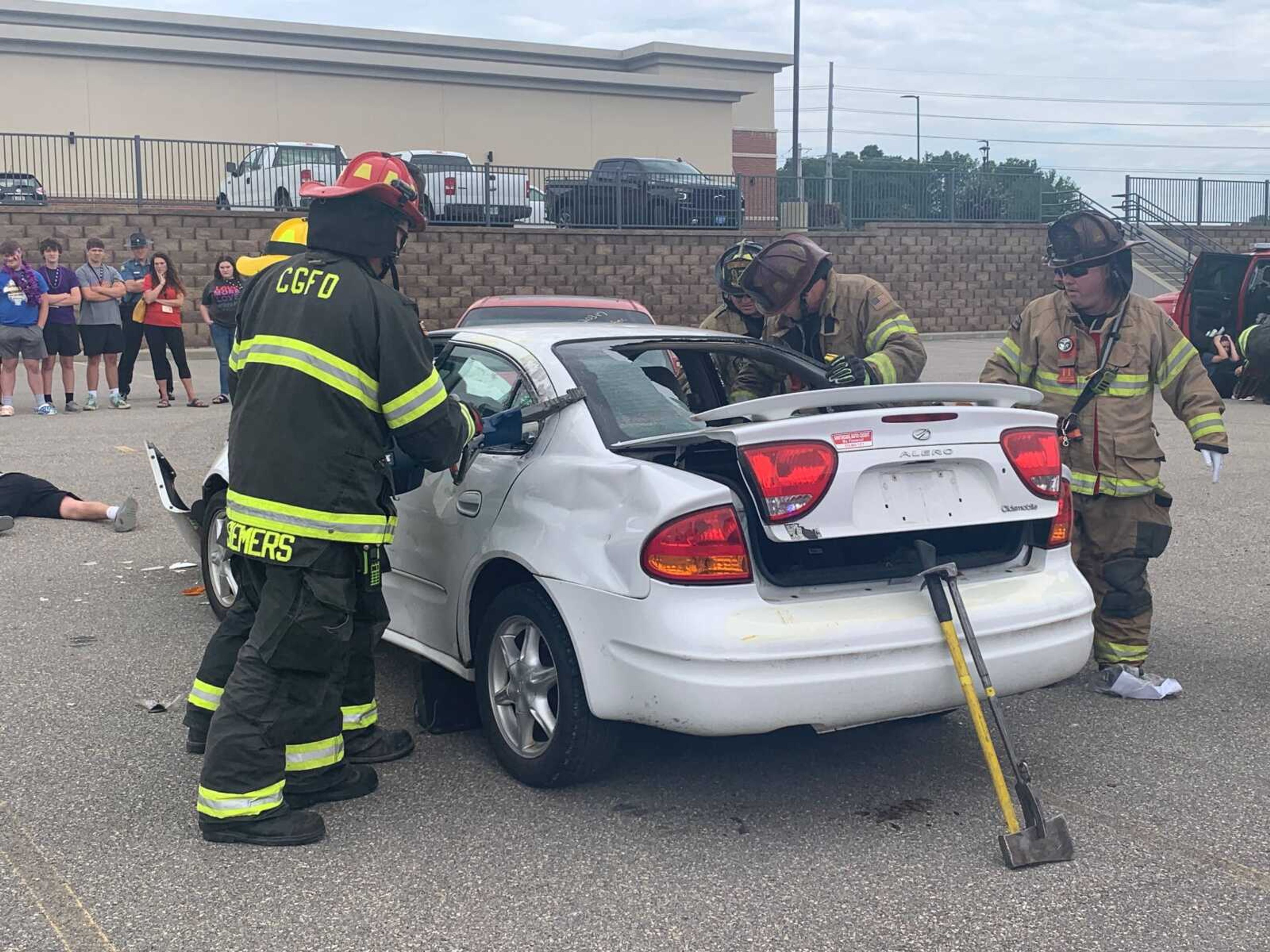 Members of the Cape Girardeau Fire Department use hydraulic spreader-cutters, or the "jaws of life", to remove the door of the vehicle to gain access of the driver at the mock DWI crash on Friday.&nbsp;