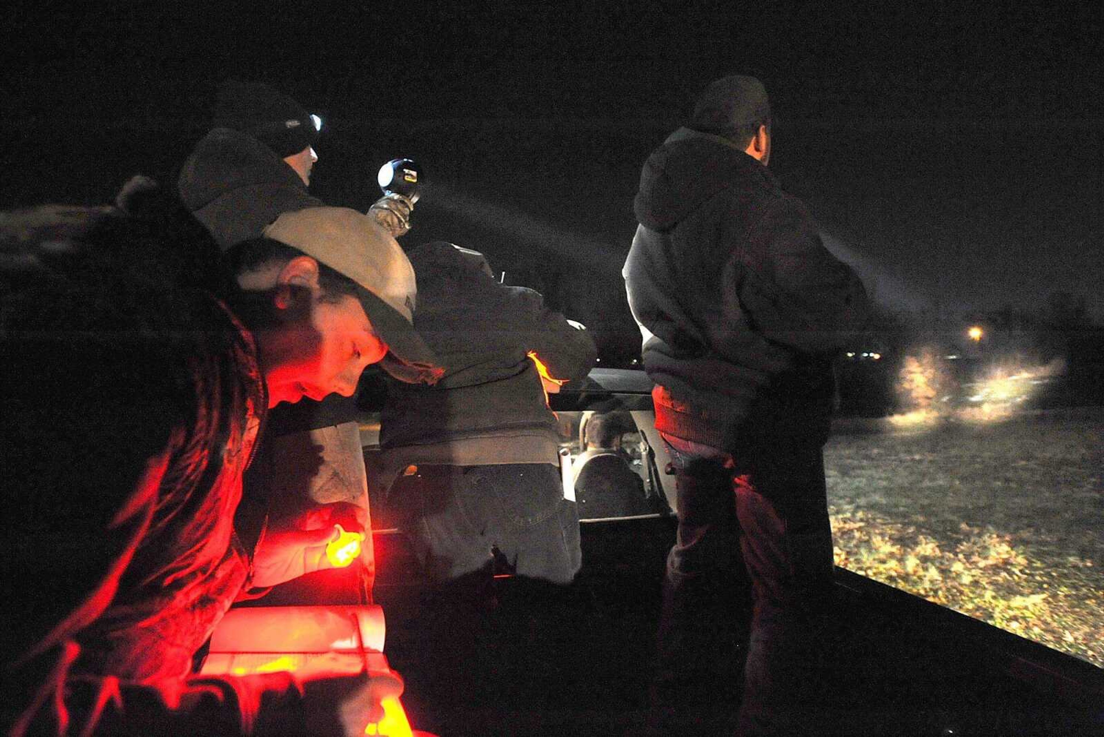 Cody Roberts, a biology graduate student at Southeast Missouri State University, records data as Bob Gillespie, top left, and Matt Bowyer, right, spot a group of deer off Farrar Drive during Tuesday&#8217;s deer survey in Cape Girardeau. (Laura Simon)