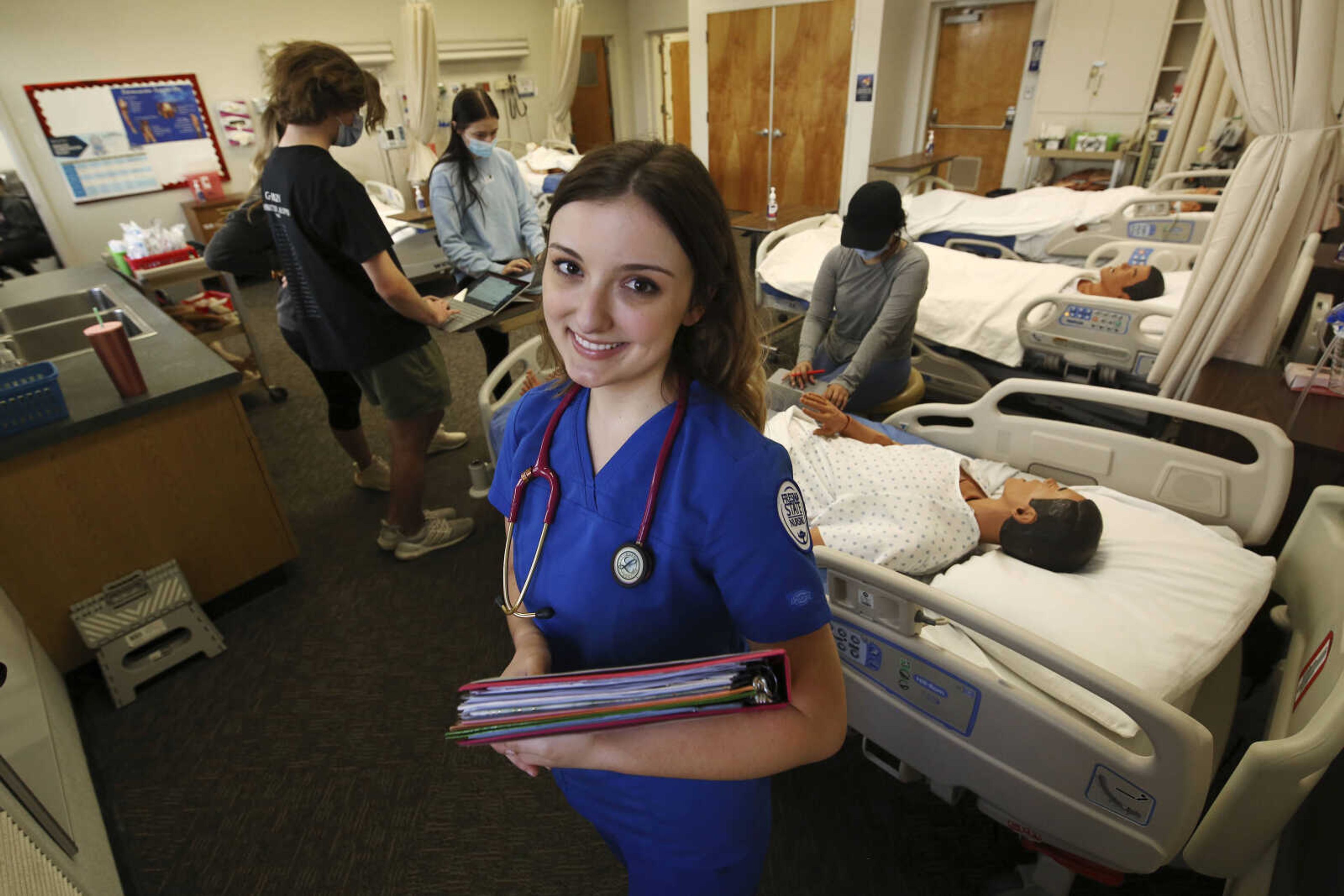 First year nursing student Emma Champlin in her clinical laboratory class at Fresno State on Wednesday, Oct. 13, 2021, in Fresno, California. Champlin said like many of her classmates, she saw the pandemic as a chance to learn critical-care skills and to help at a time when those abilities are needed.