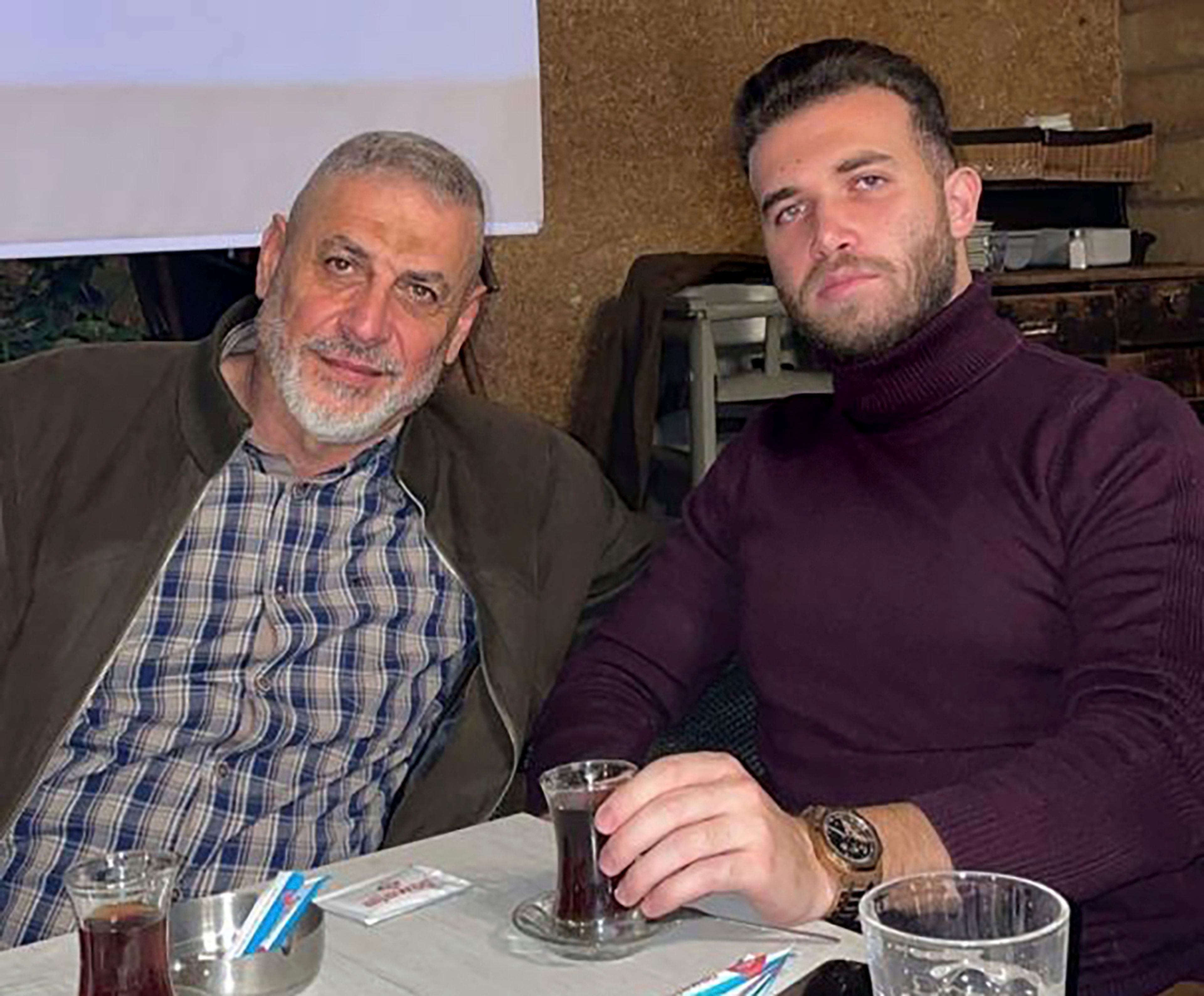 This December 2022 photo provided by Reda Gharib, shows Reda Gharib, right, and his father, Ahmed, who was killed with other family members in an Israeli airstrike on the family's apartment in al-Housh, in the southern Lebanese city of Tyre on Sept. 23, at the start of an escalation in its war against Hezbollah. (Reda Gharib via AP)