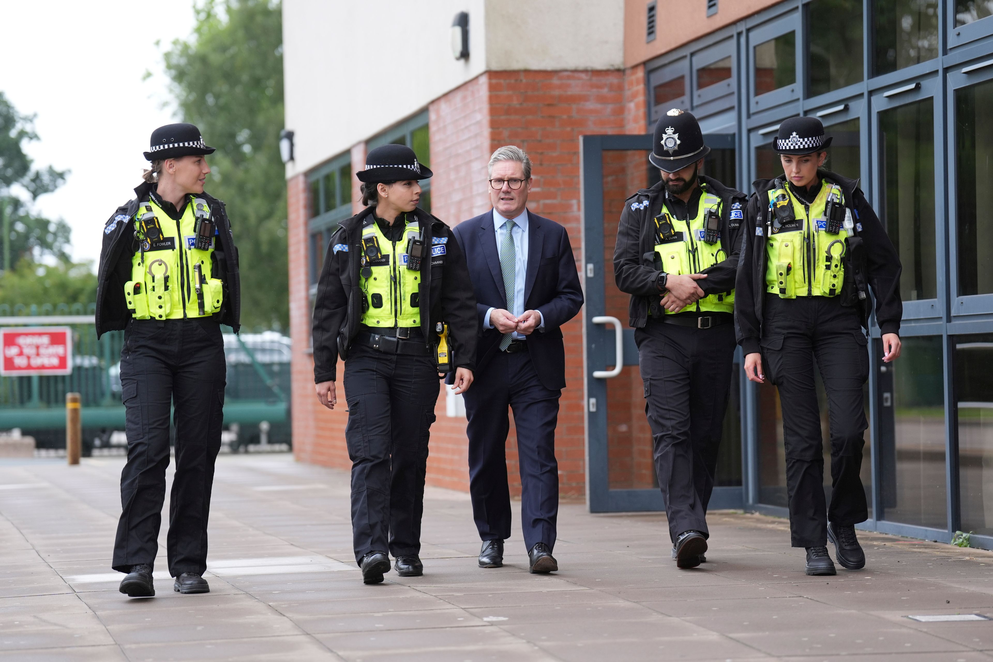 FILE - British Prime Minister Sir Keir Starmer, centre, walks with members of the West Midlands Police Force at Arden Academy in Solihull, West Midlands, England, Thursday Aug. 8, 2024. (Joe Giddens/PA via AP, Pool, FIle)