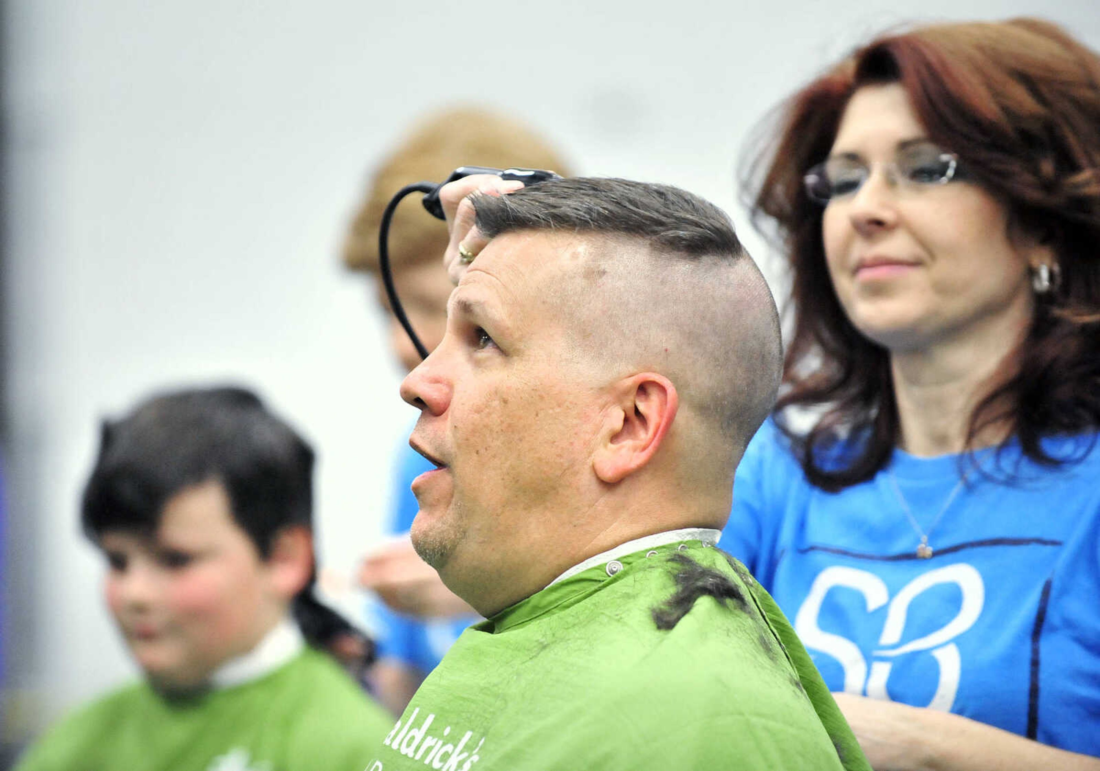 Jackson school superintendent John Link reacts as April Whiteside shaves his head on Saturday, March 4, 2017, during the St. Baldrick's Foundation fundraiser at Old Orchard CrossFit in Jackson.