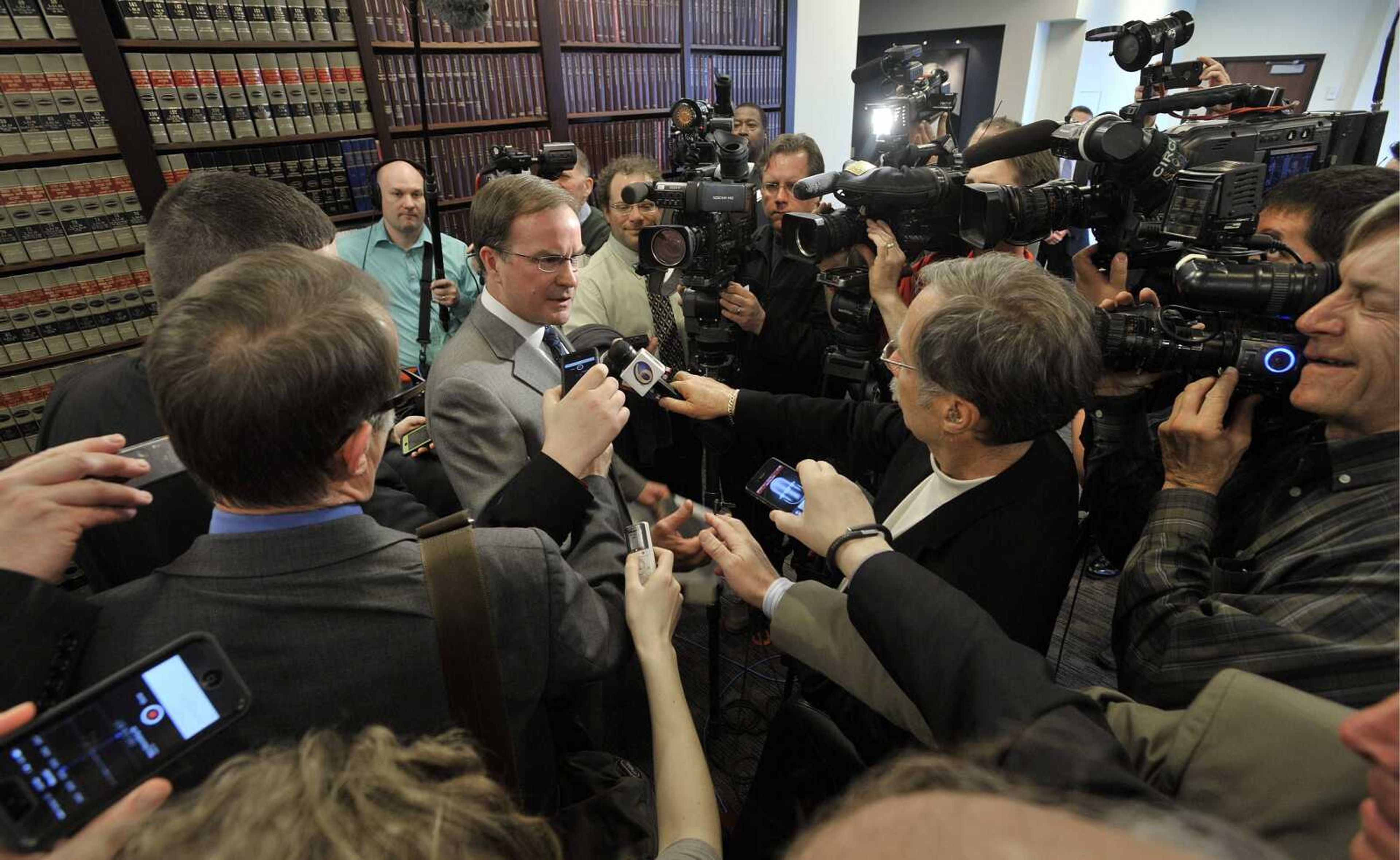 Michigan Attorney General Bill Schuette, center left, speaks about the United States Supreme Court's decision Tuesday regarding the state's Affirmative Action law involving college admissions, during a news conference in Lansing, Mich. (AP Photo/The Detroit News, Dale G. Young)