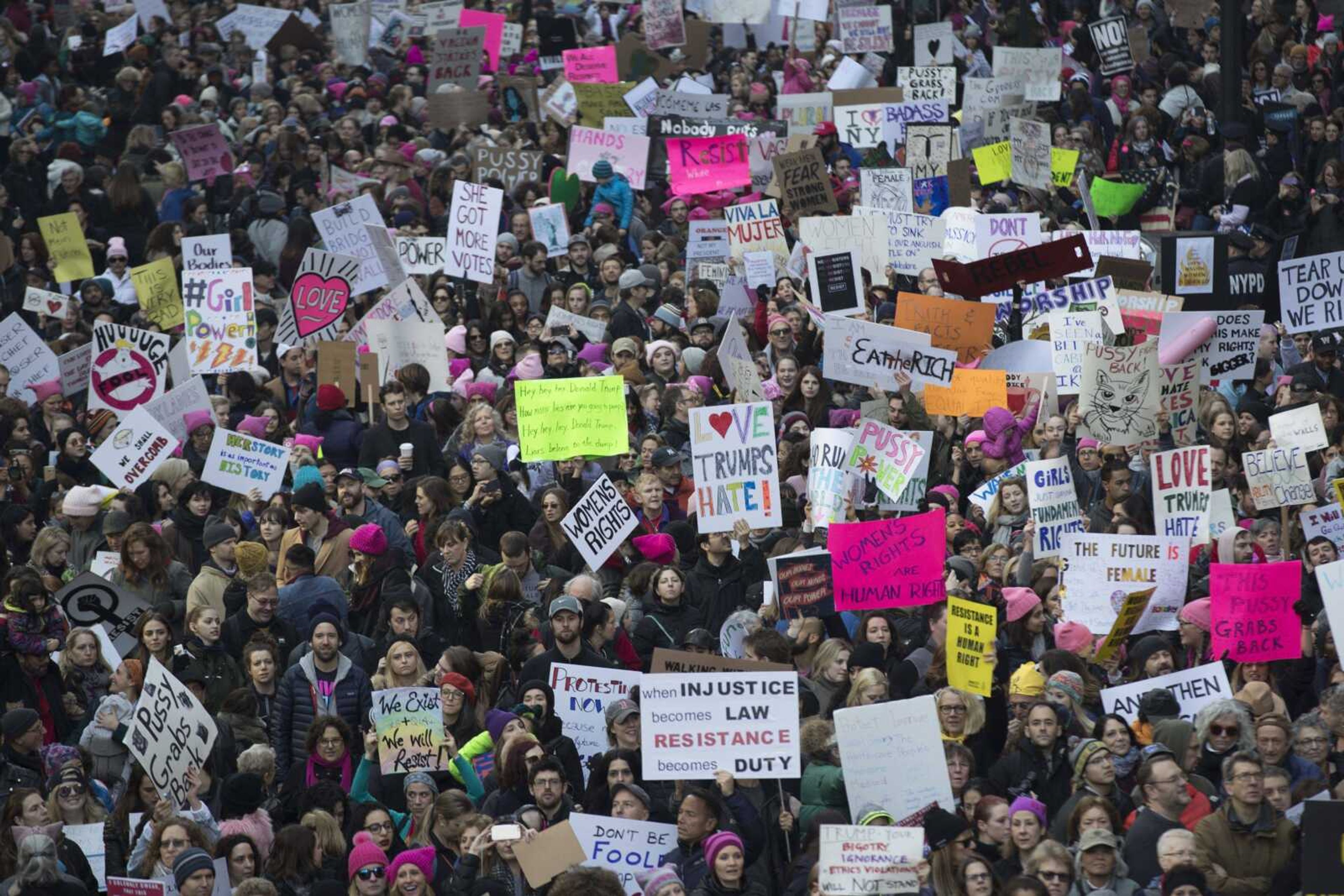 Demonstrators march across 42nd Street during a women's march Saturday in New York. The march is being held in solidarity with similar events taking place in Washington and around the nation.