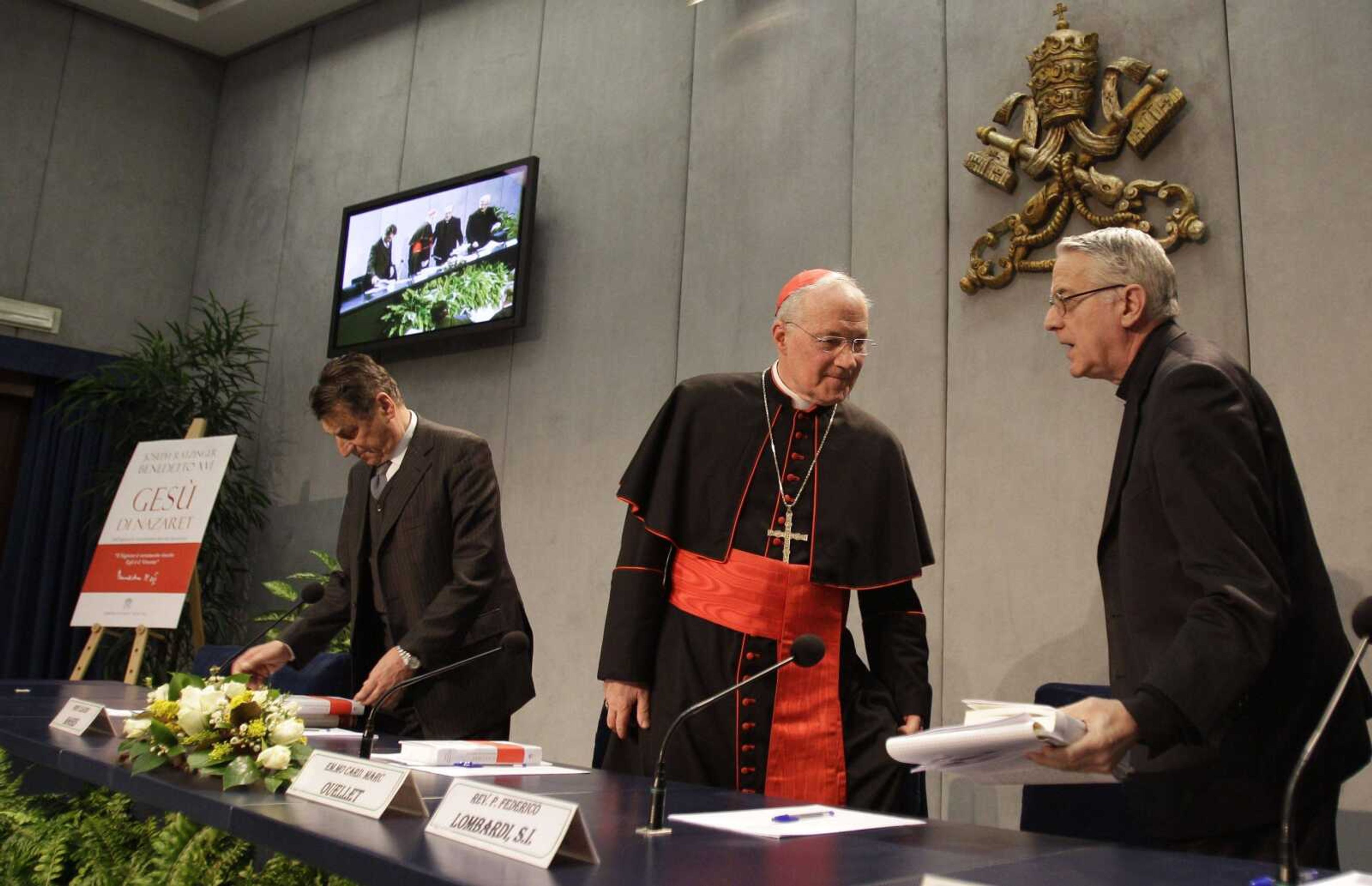 From left, professor Claudio Magris, Cardinal Marc Ouellet and Vatican spokesman the Rev. Federico Lombardi arrive for the presentation of Pope Benedict XVI's new book in the Vatican's press room Thursday. (Alessandra Tarantino ~ Associated Press)