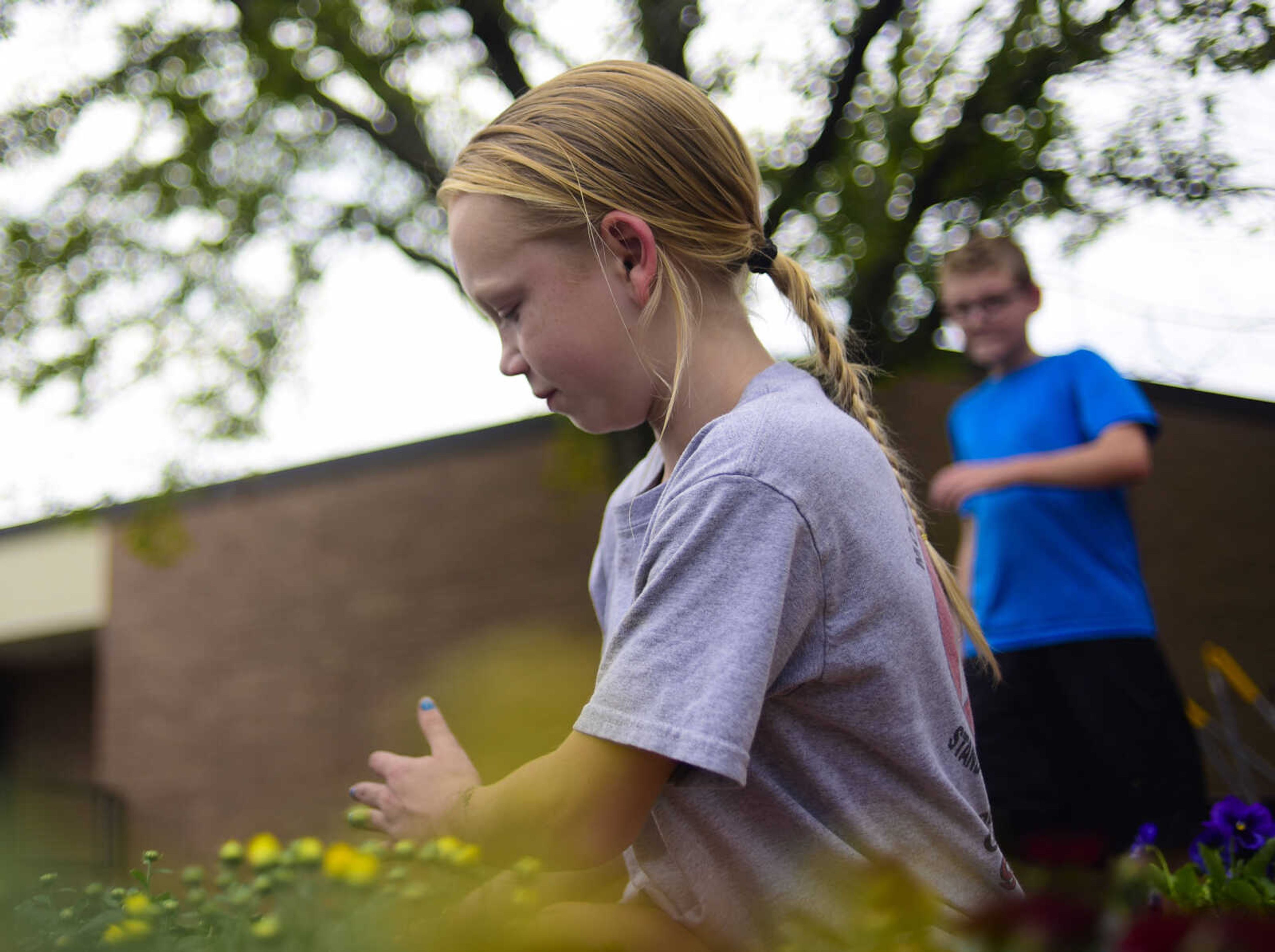 Ashley Smart plants pansies and mums in flower beds donated by Lowe's as part of the Lowe's Heroes program Monday, Sept. 18, 2017 at West Lane Elementary in Jackson. Lowe's donated 12 flower beds, 10 picnic tables and three new benches for the school.