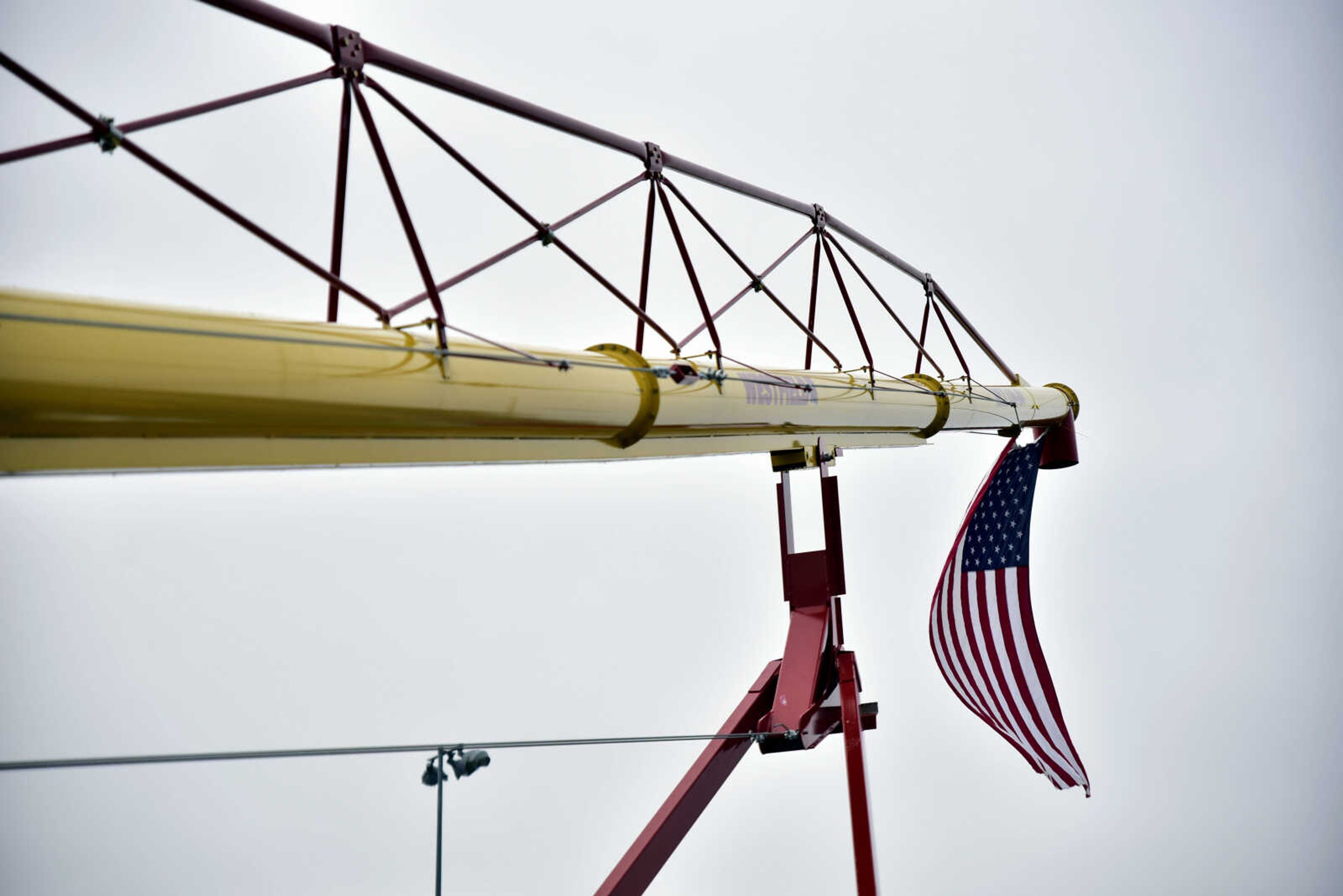 An American flag flies on the end of farm equipment at the Cousin Carl Farm Show on Saturday, March 10, 2018, at Arena Park in Cape Girardeau.