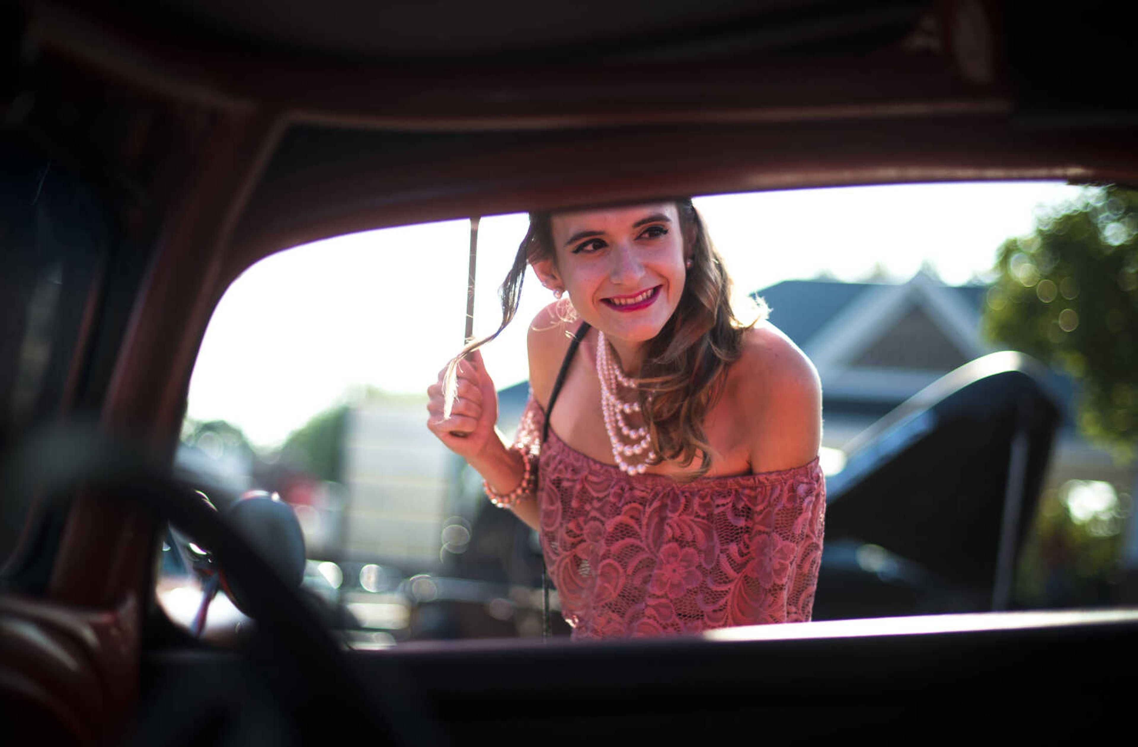 Avonlea Schoenberg looks at a classic car during the Perryville Pinup contest Saturday, Sept. 2, 2017 in downtown Perryville.